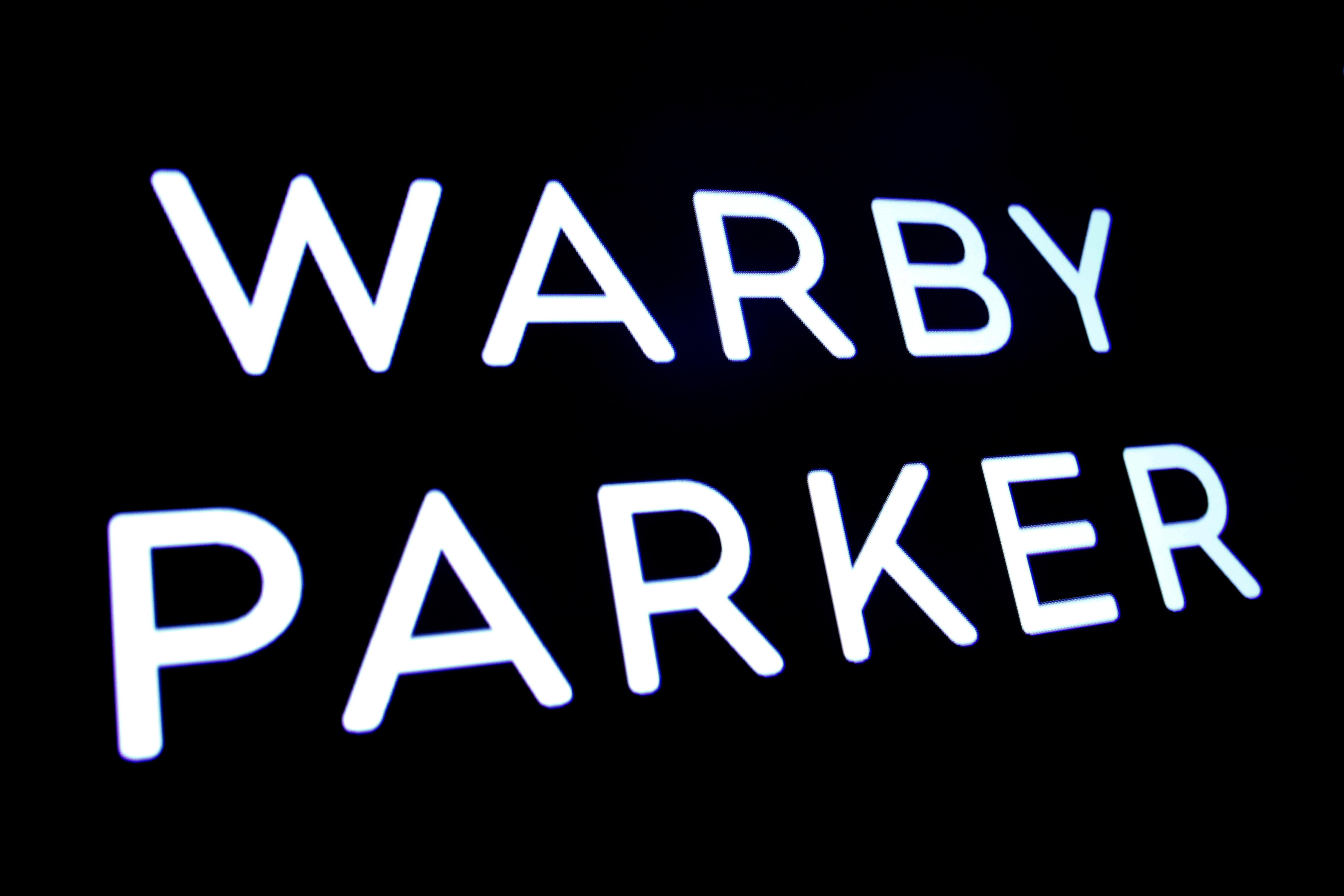 The company logo for eyeglass retailer Warby Parker is displayed on a screen during the company's direct listing at the NYSE in New York