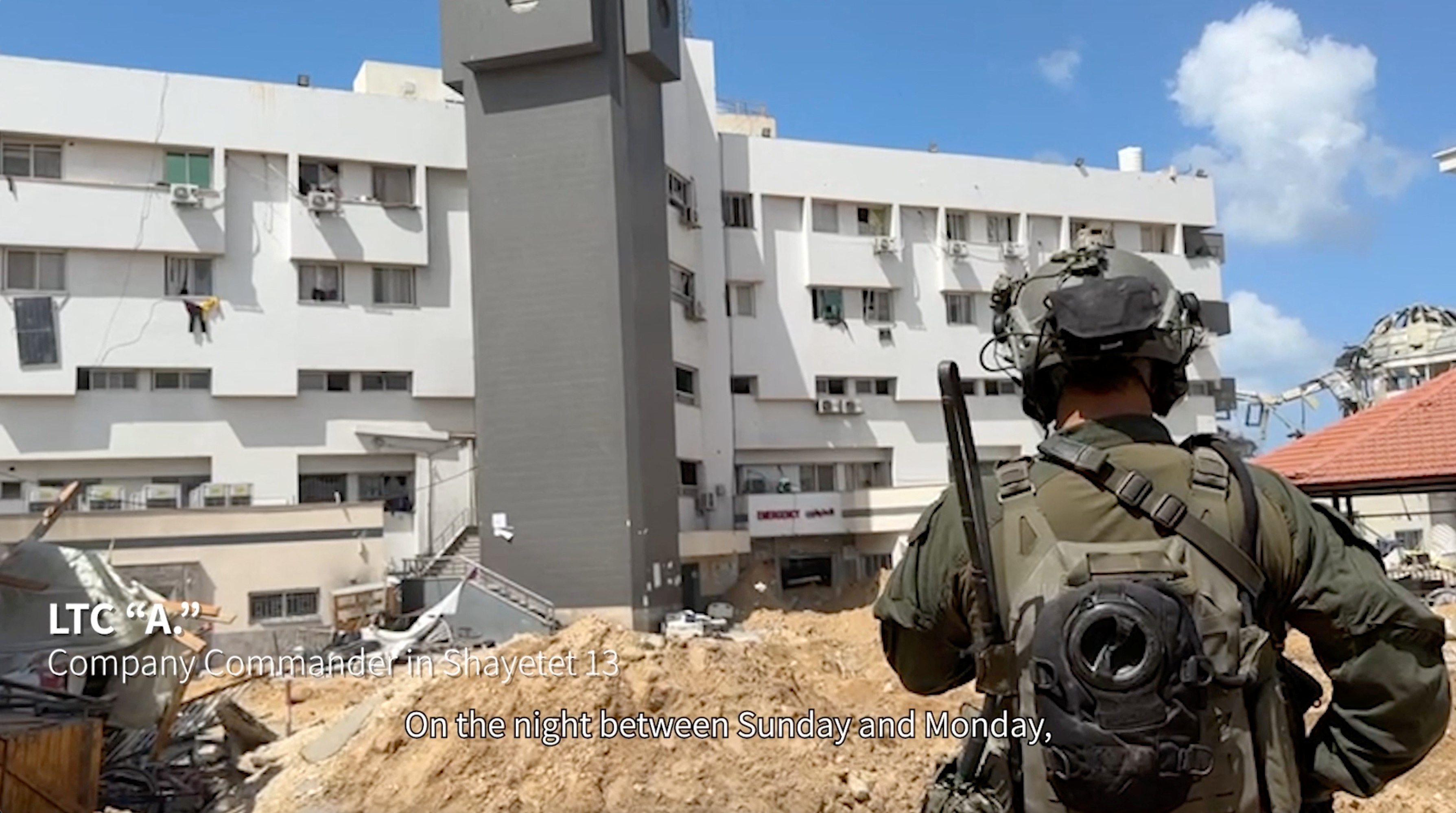 An Israeli soldier stands near al-Shifa hospital, where the Israeli army says weapons were found, in Gaza City