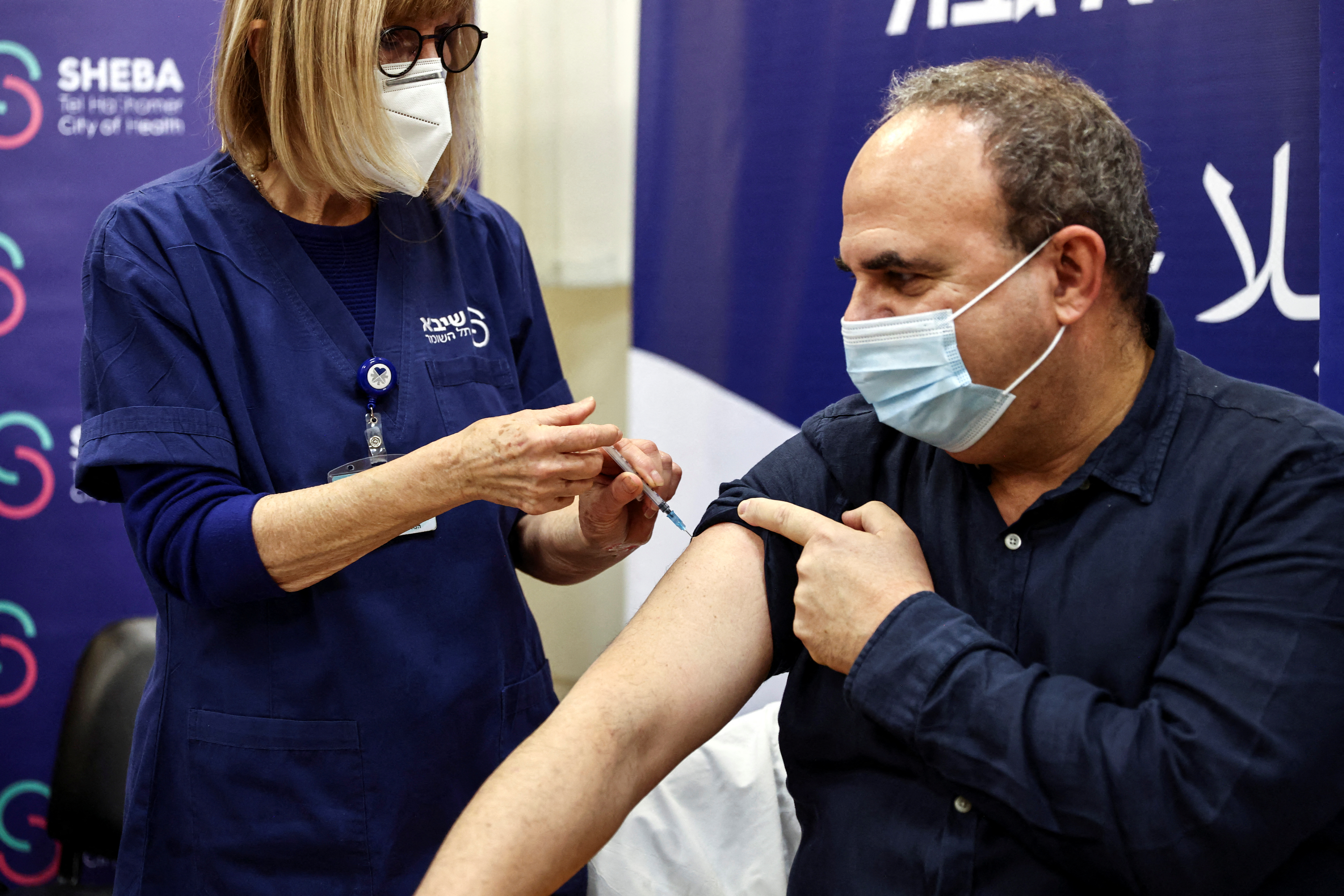 A man receives a fourth dose of coronavirus disease (COVID-19) vaccine as part of a trial in Israel, as Health Ministry is considering offering the second booster to the elderly and immunocompromised, at Sheba Medical Center in Ramat Gan
