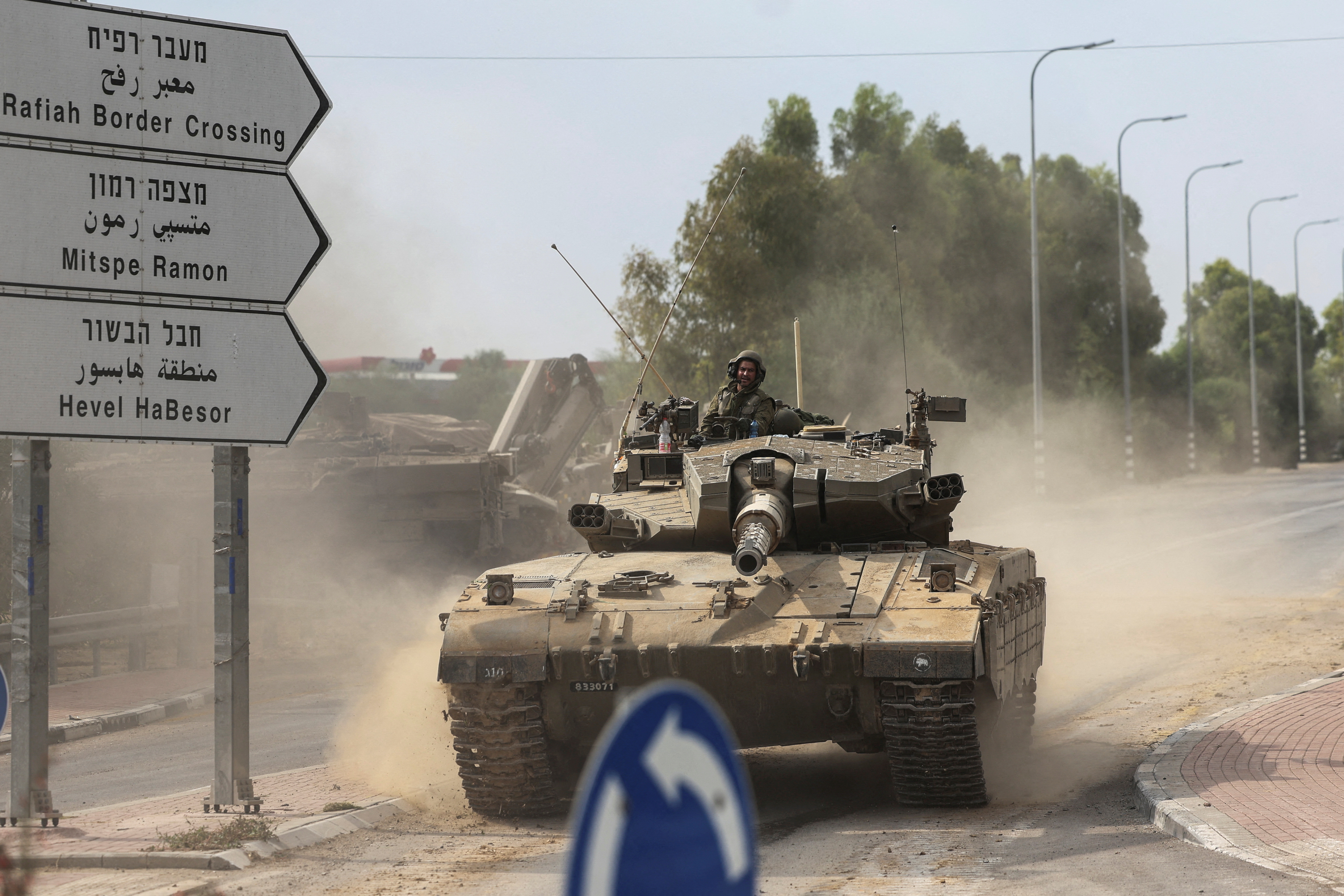 Israeli soldiers drive in a tank by Israel's border with Gaza in southern Israel