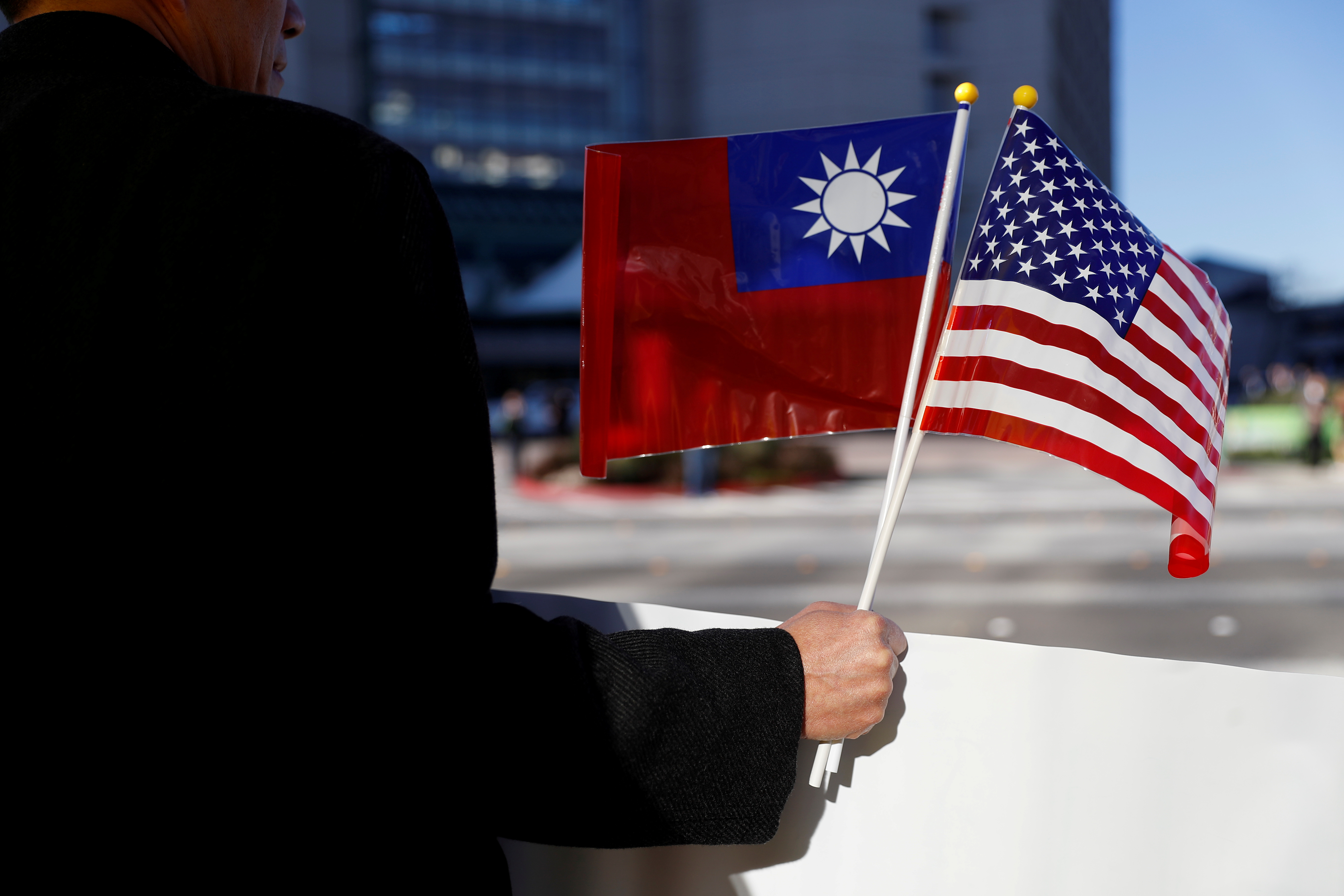 FILE PHOTO - A demonstrator holds flags of Taiwan and the United States in support of Taiwanese President Tsai Ing-wen during an stop-over after her visit to Latin America in Burlingame