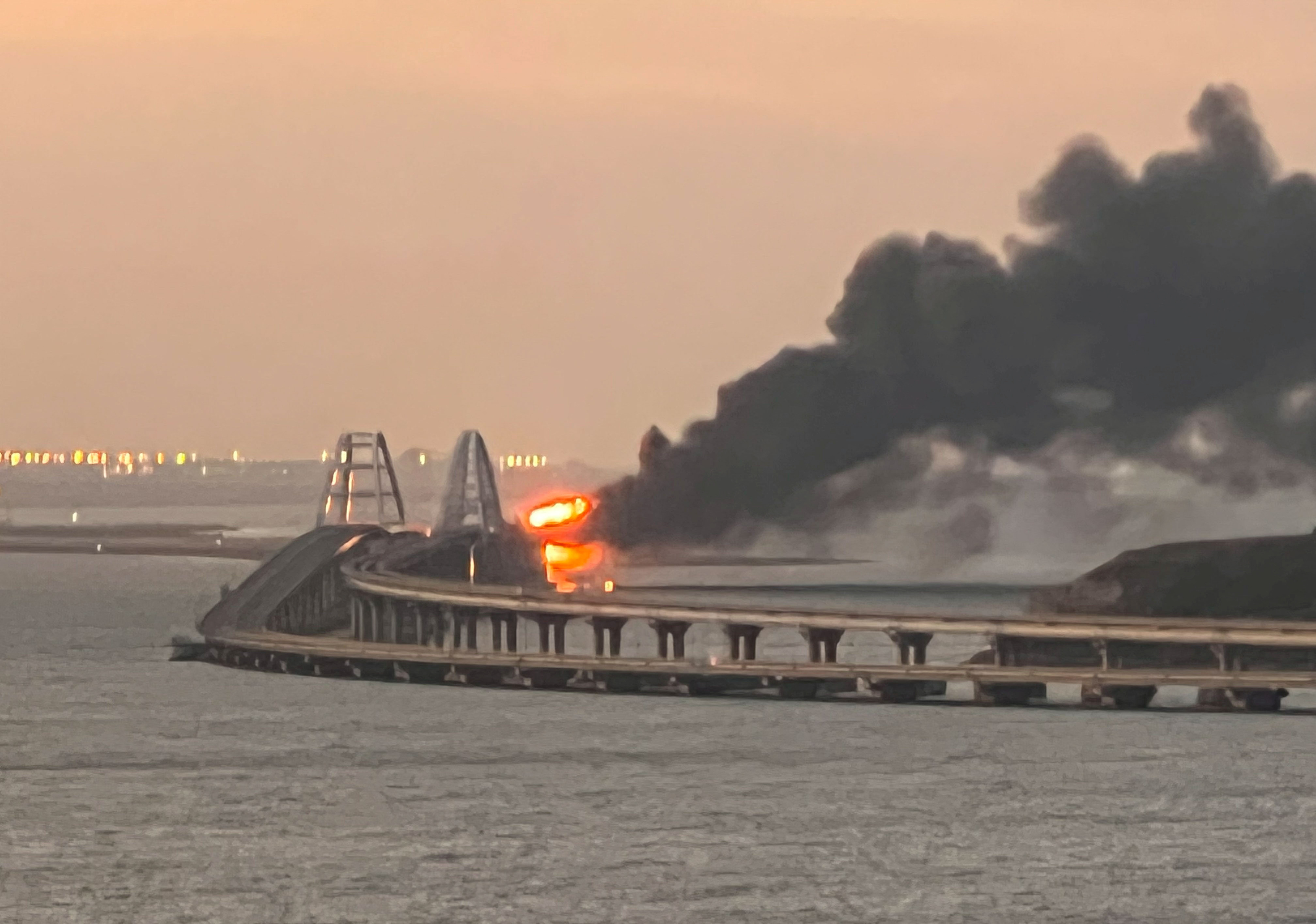 A view shows a fire on the Kerch bridge at sunrise in the Kerch Strait, Crimea