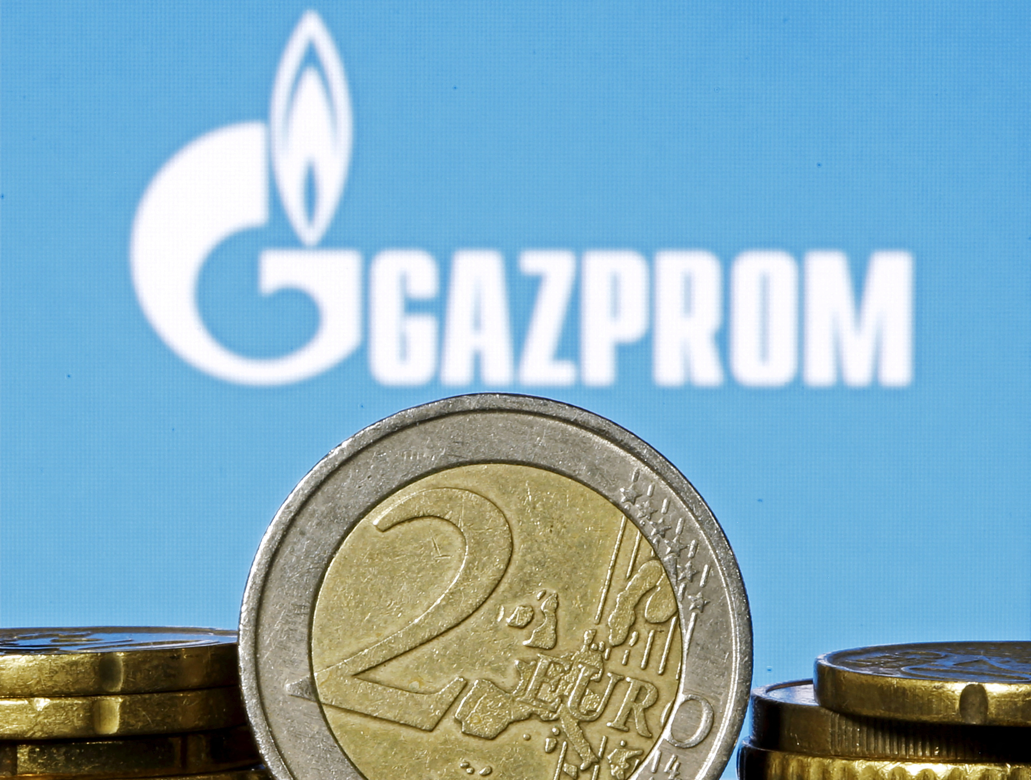 Euro coins are seen in front of displayed logo of Gazprom in this picture illustration taken in Zenica