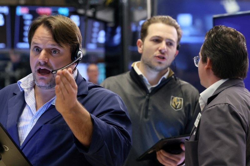 Traders work on the floor of the NYSE in New York