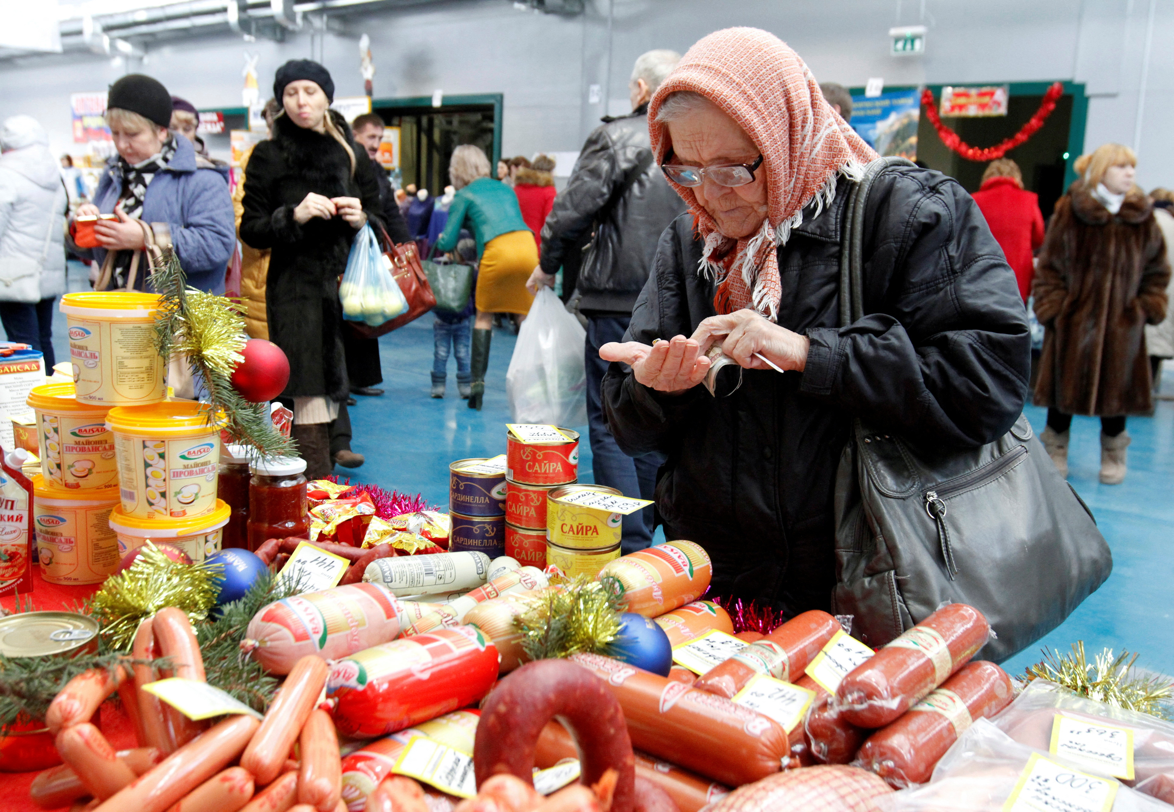 A woman counts money at a food fair in the village of Ulyanovka in Stavropol region