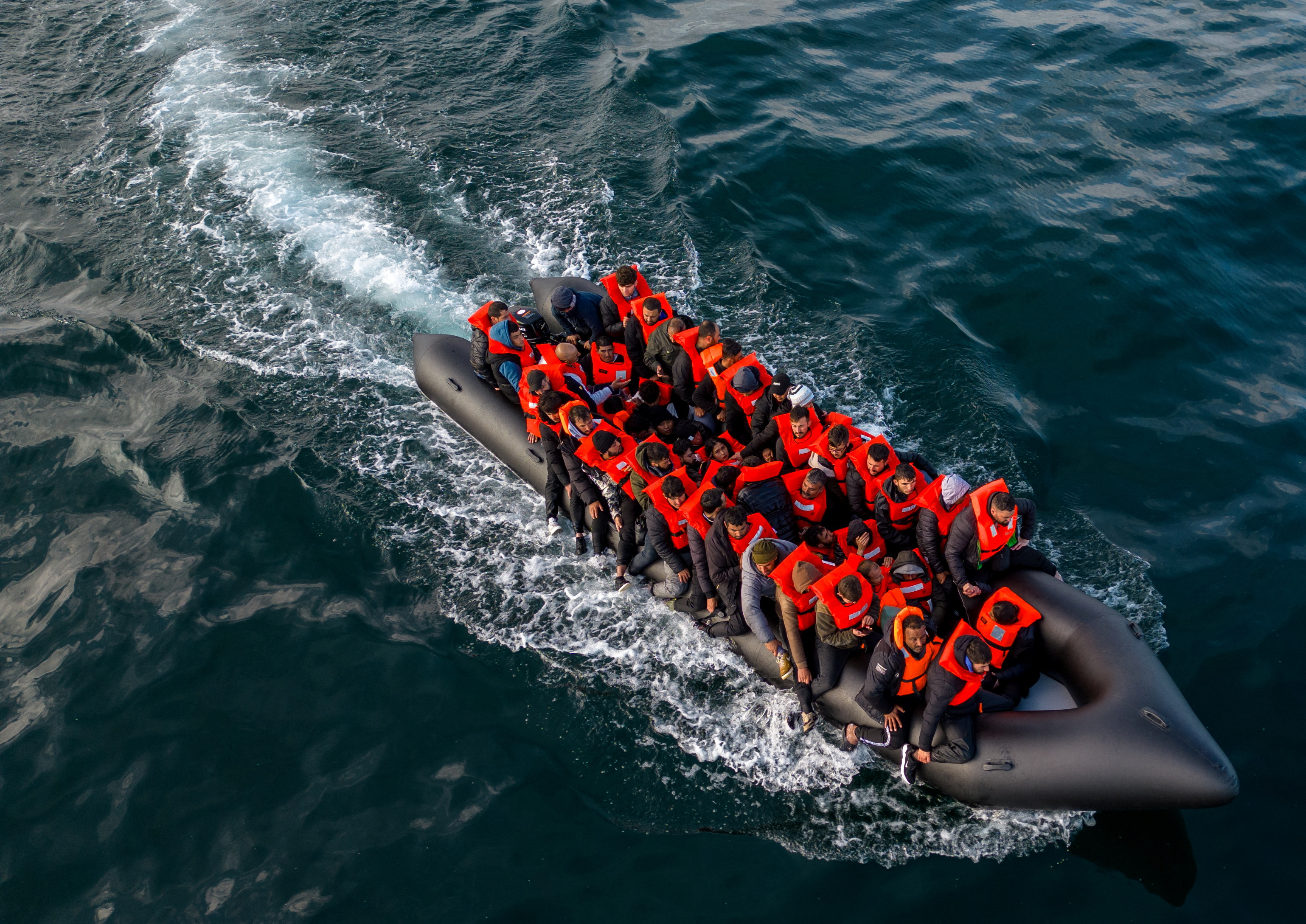 Migrants cross the English Channel in small boats