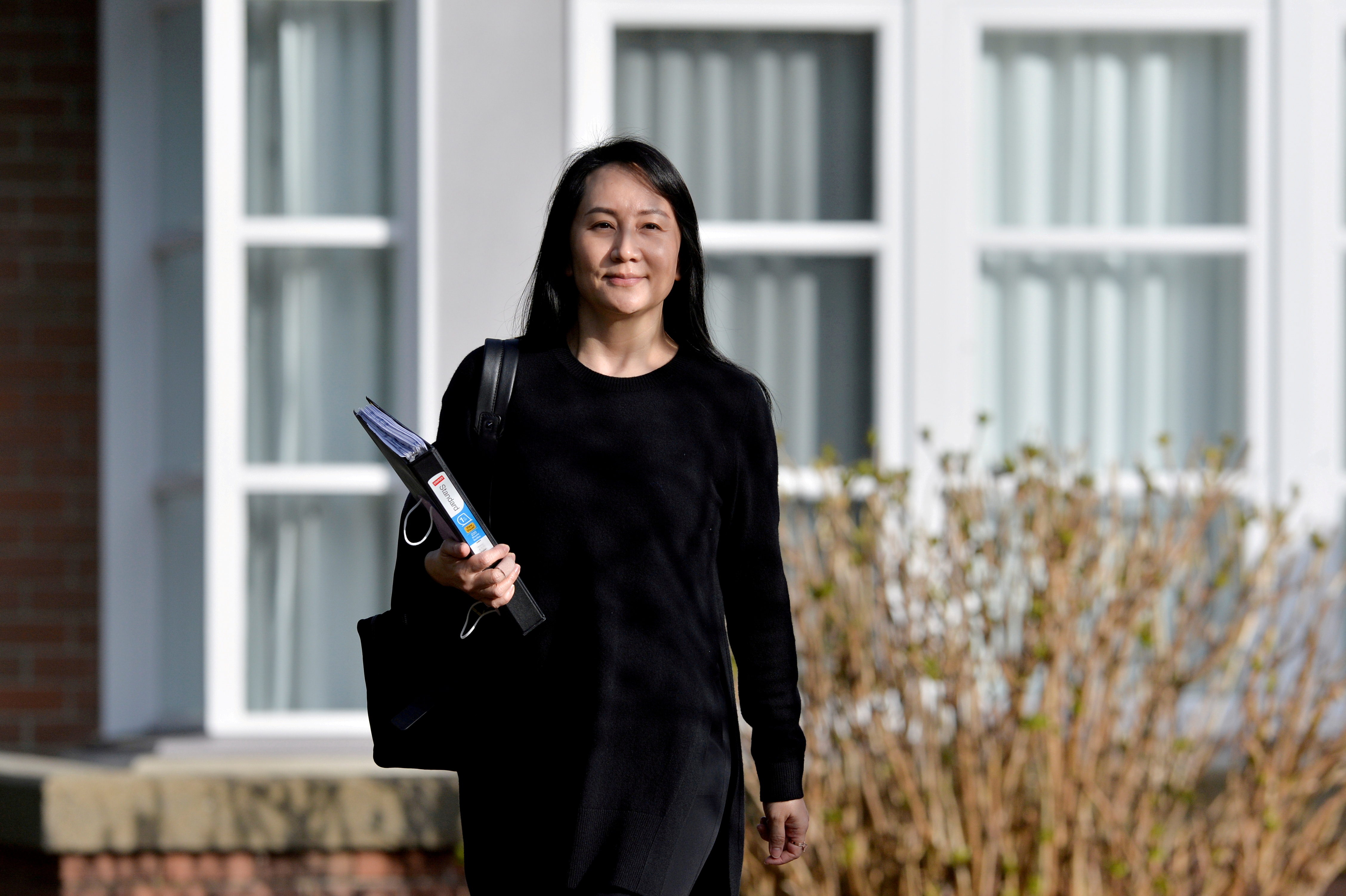 Huawei Technologies Chief Financial Officer Meng Wanzhou leaves her home to attend a court hearing in Vancouver, British Columbia, Canada March 22, 2021. REUTERS/Jennifer Gauthier/File Photo