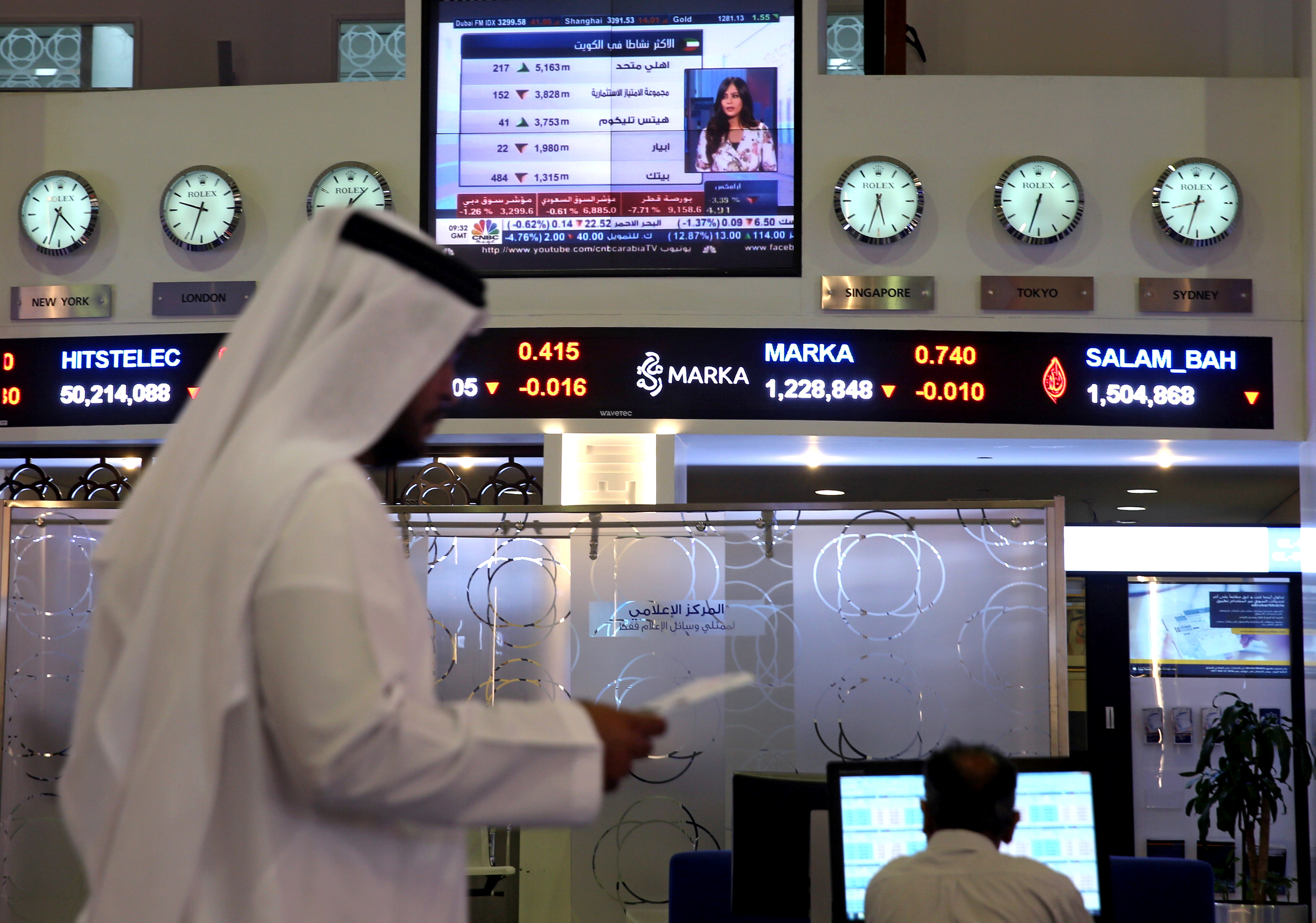 Traders monitor stock information at Dubai Financial Market, in Dubai