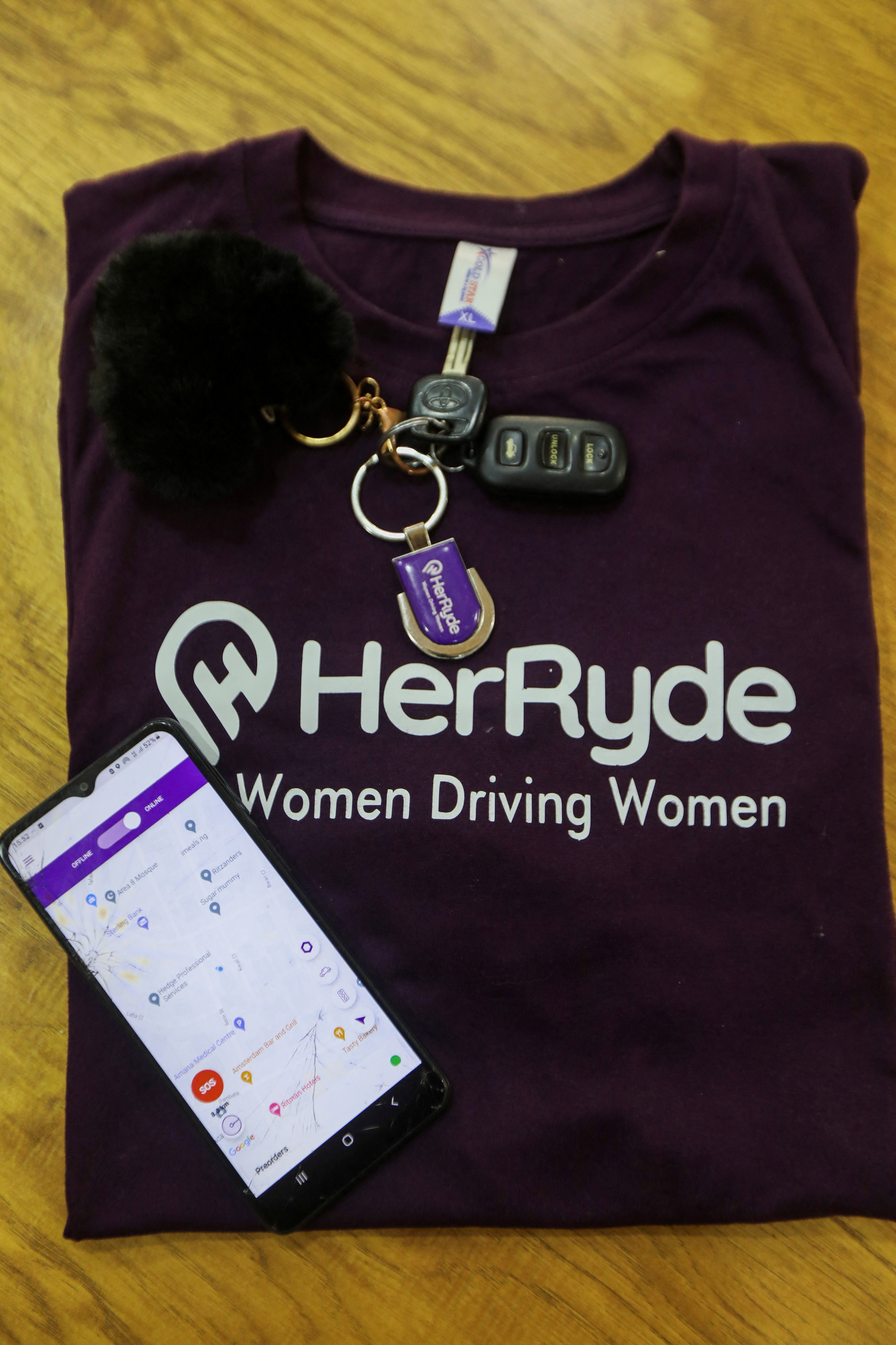 A car key and a t-shirt of HerRyde, a ride-hailing app with exclusively women drivers, are placed on a table, in Abuja