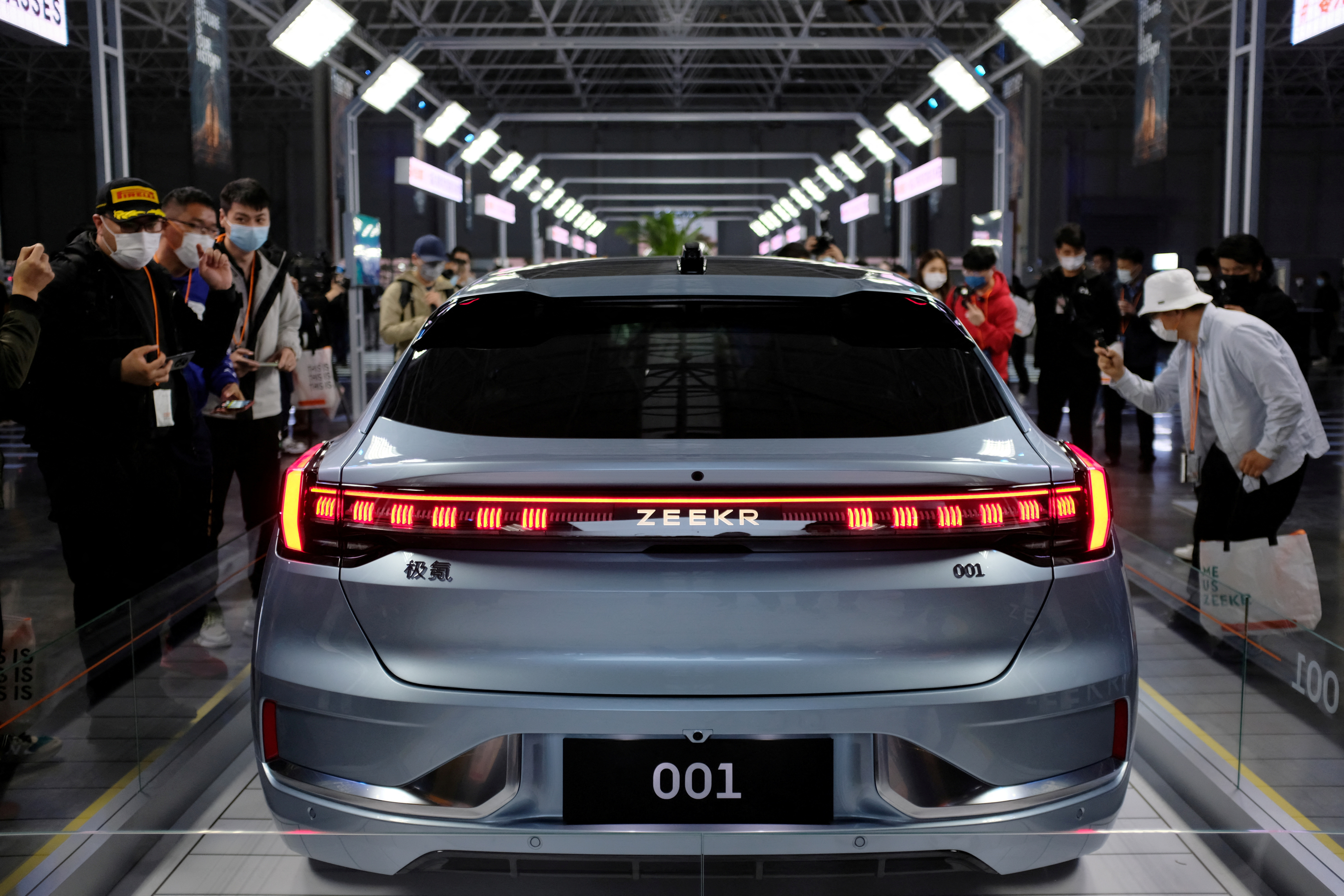 Visitors check a Zeekr 001, a model from Geely's Zeekr brand, at its factory in Ningbo