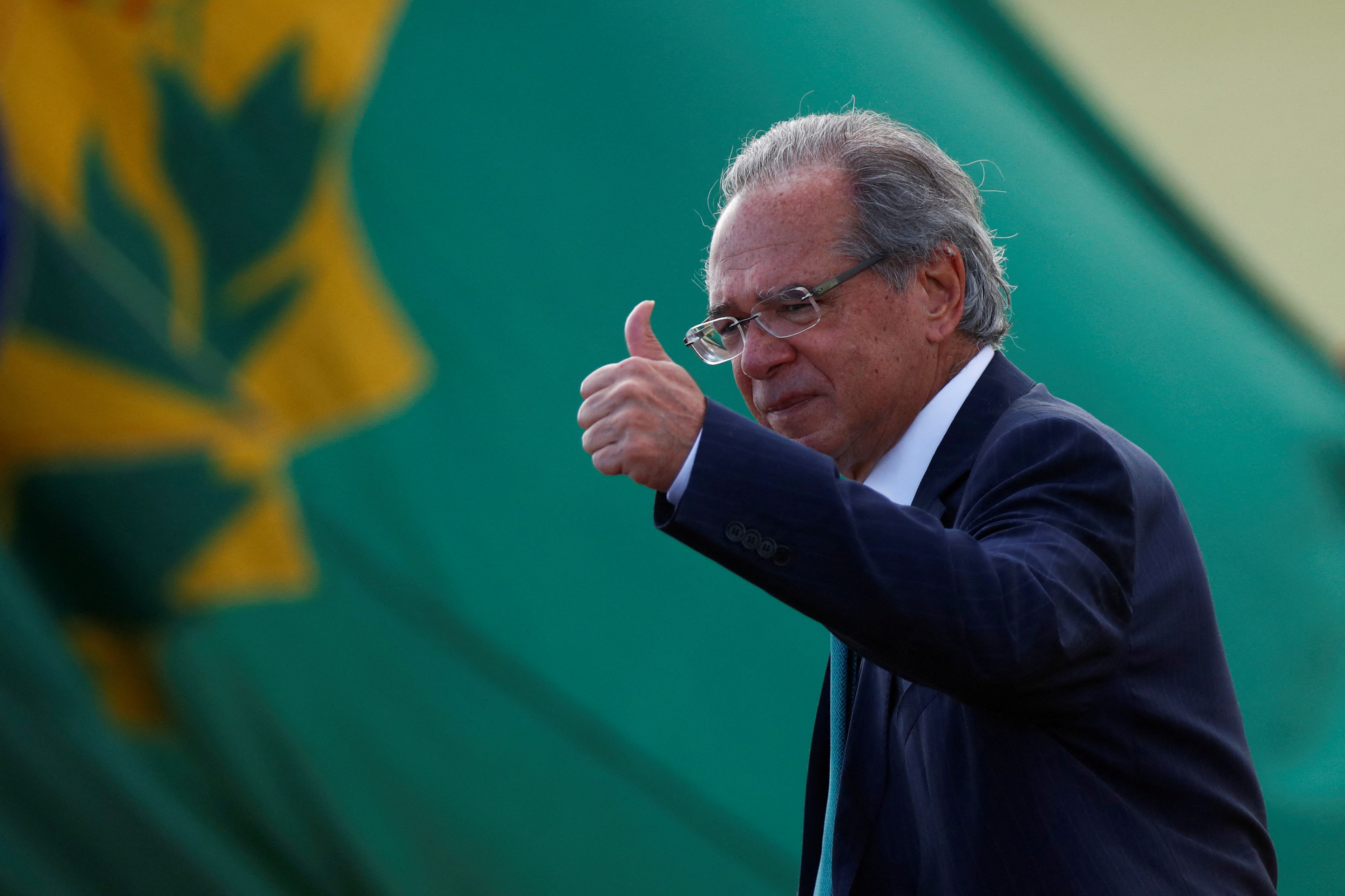 Brazil's Economy Minister Paulo Guedes walks before a national flag hoisting ceremony in front of Alvorada Palace in Brasilia