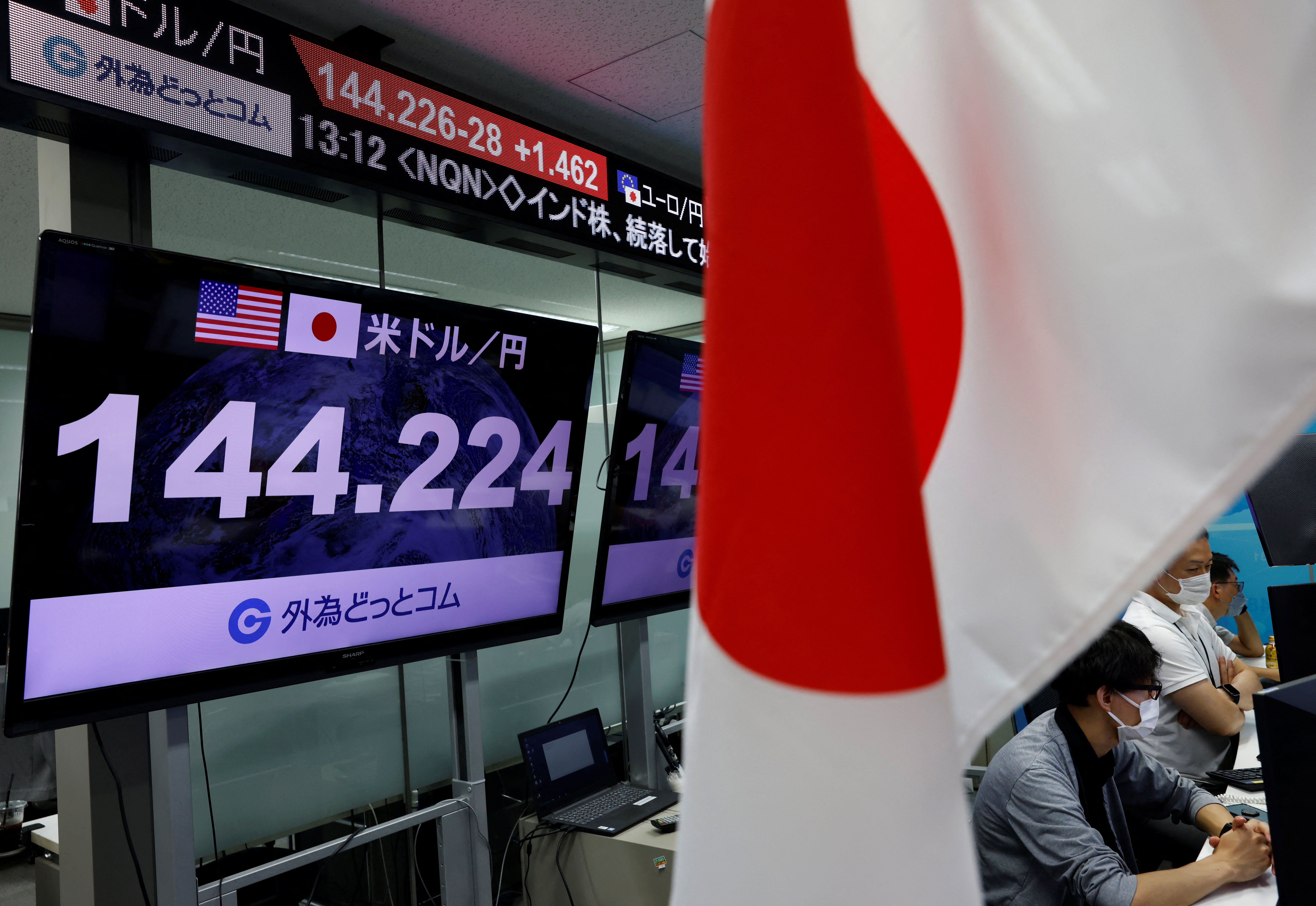 Employees of the foreign exchange trading company Gaitame.com work in front of monitors, in Tokyo