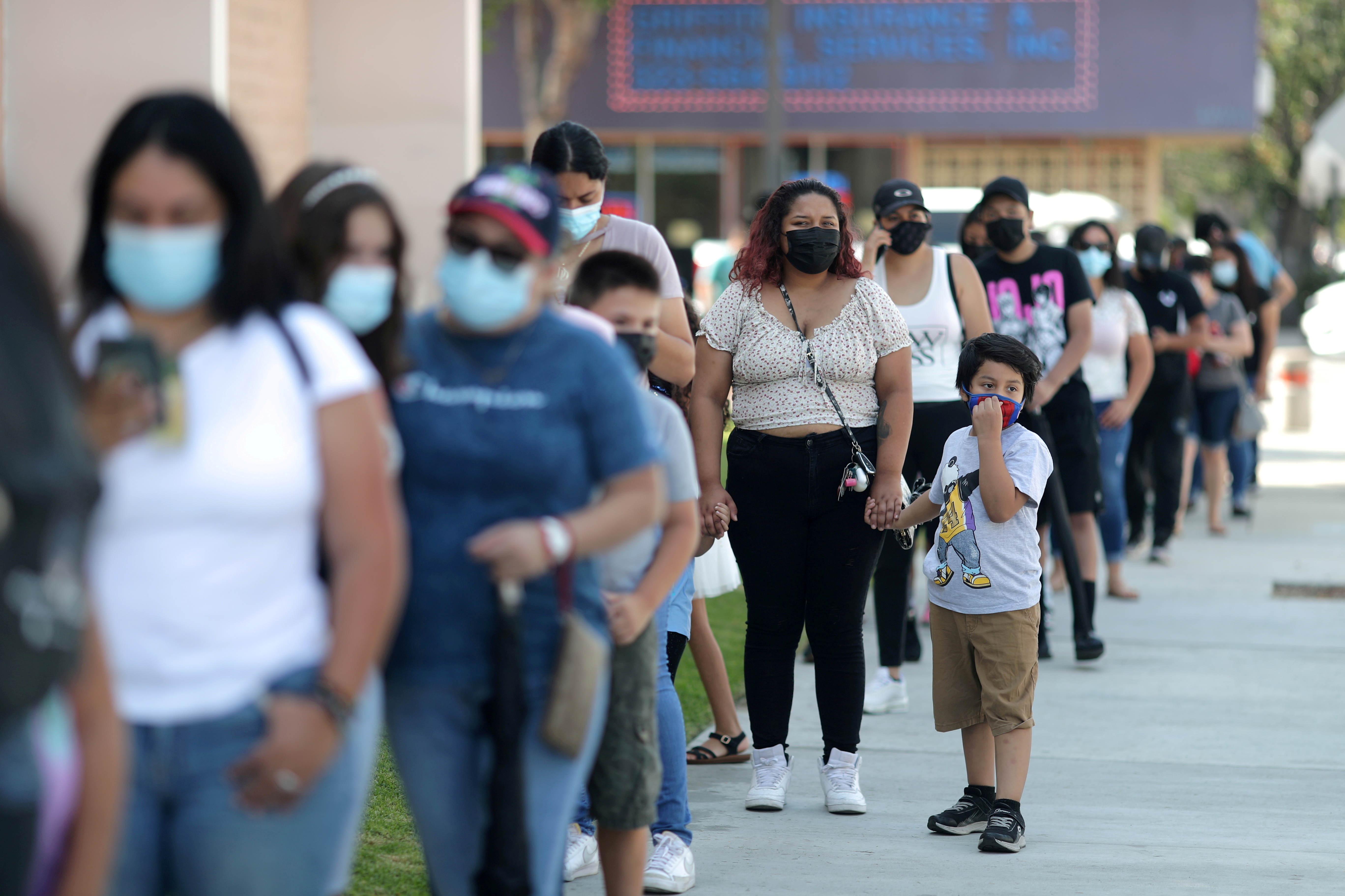 People wait in line for a COVID-19 test at a back-to-school clinic in Los Angeles
