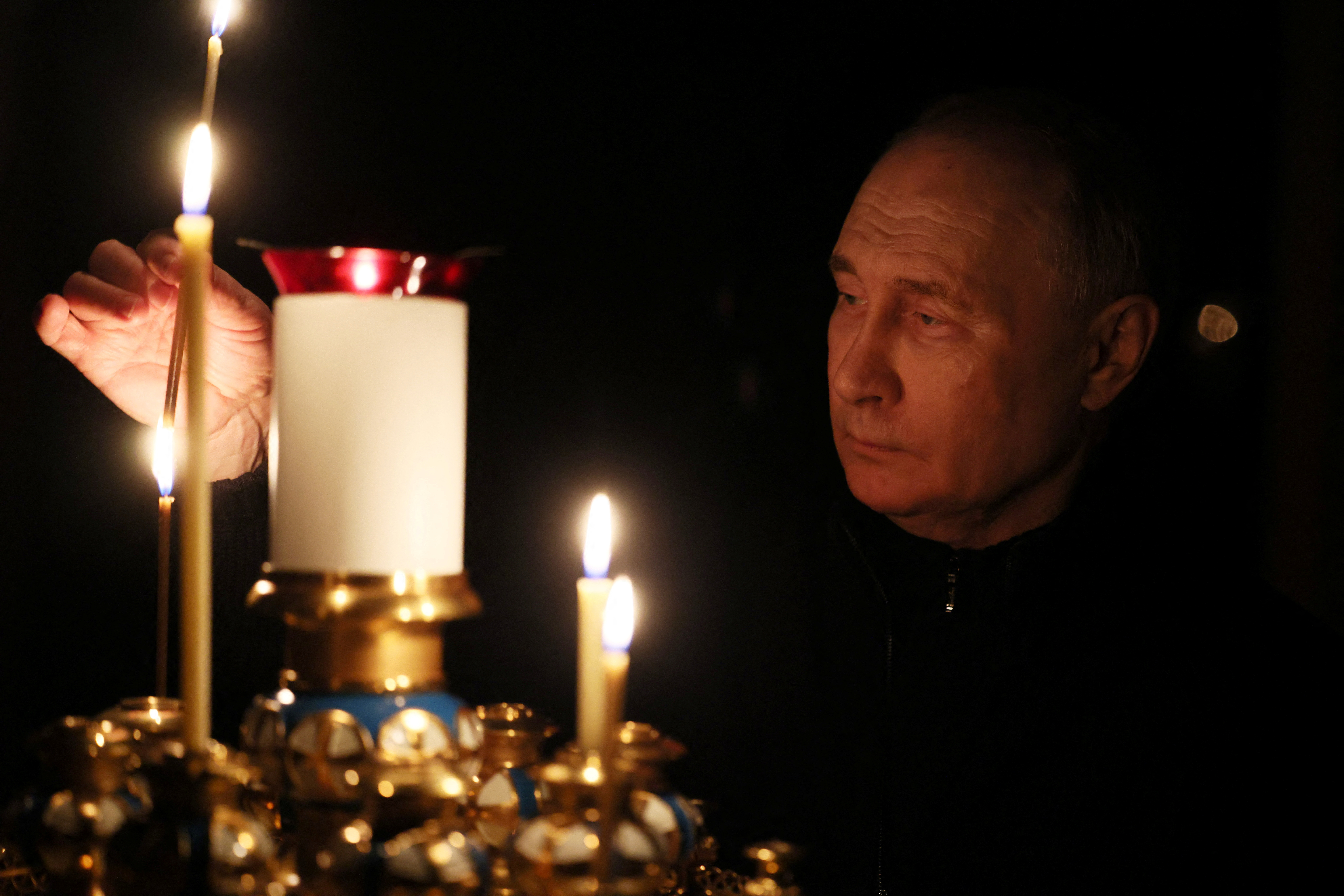 Russian President Putin lights a candle in memory of the victims of the Crocus City Hall attack, in Moscow Region