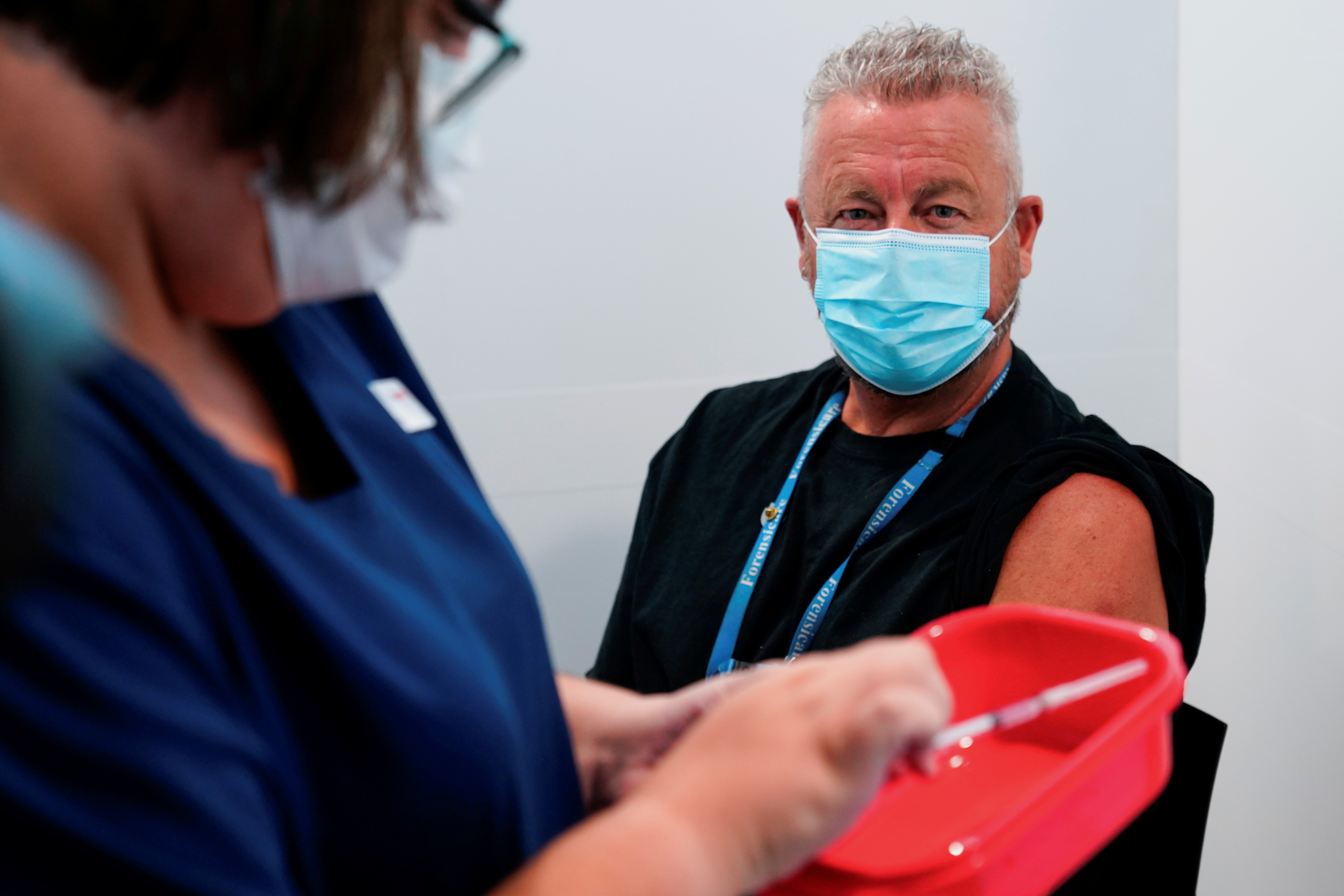 The Pfizer COVID-19 vaccine is prepared for a high-risk worker in Melbourne