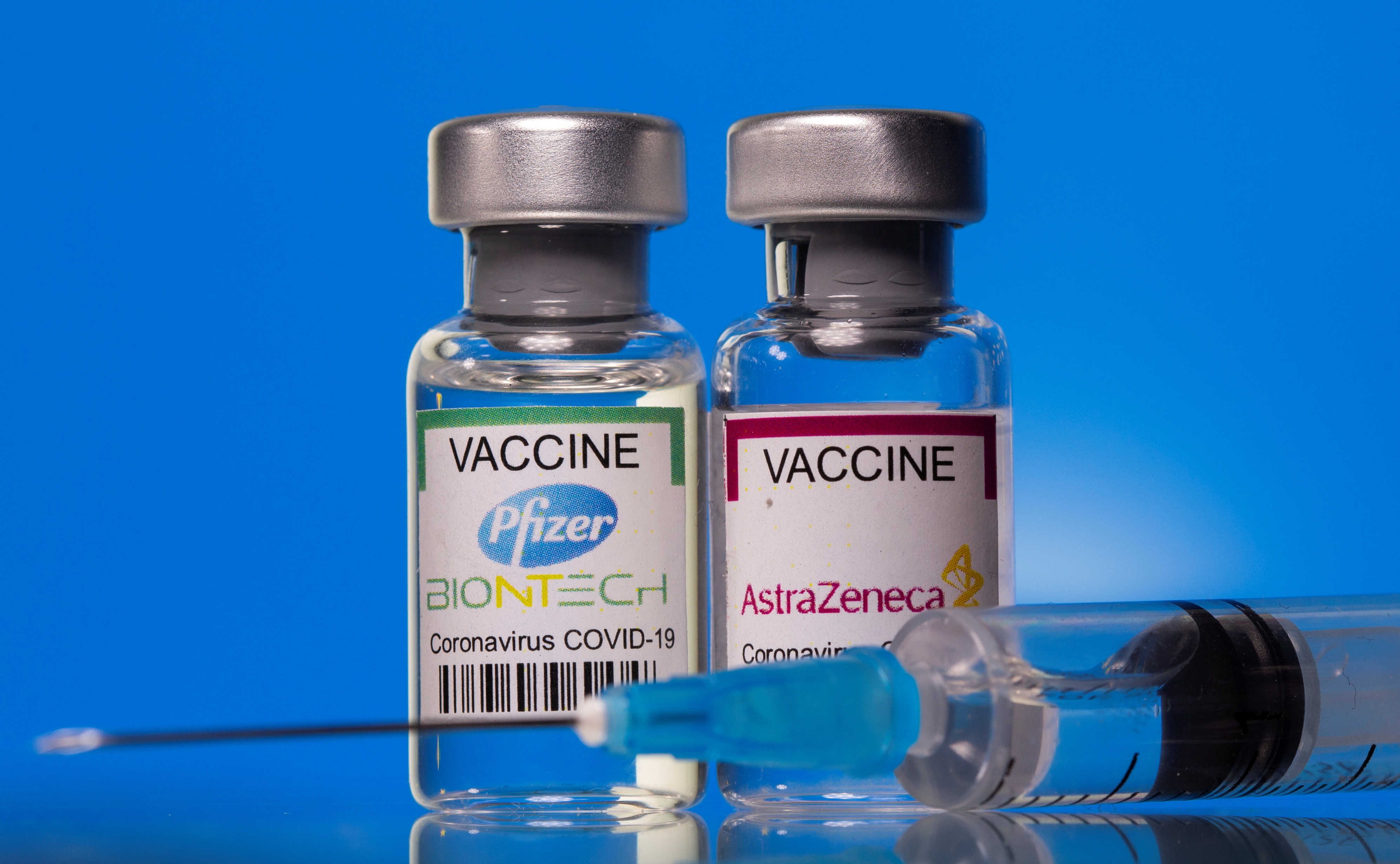 Vials with Pfizer-BioNTech and AstraZeneca COVID-19 vaccine labels are seen in this illustration picture taken March 19, 2021. REUTERS/Dado Ruvic/Illustration