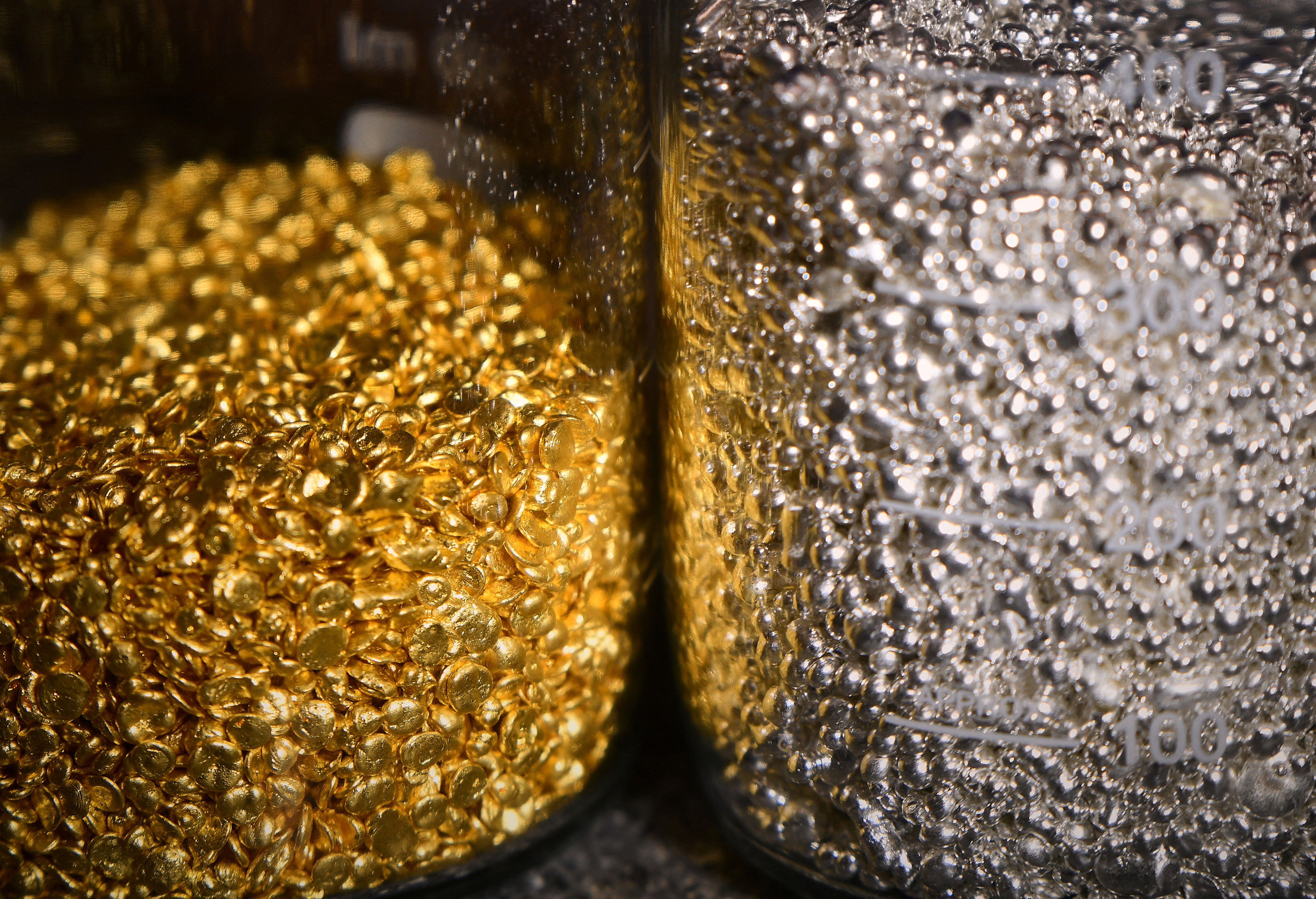 Granules of gold and silver are seen in glass jars at the Krastsvetmet non-ferrous metals plant in Krasnoyarsk