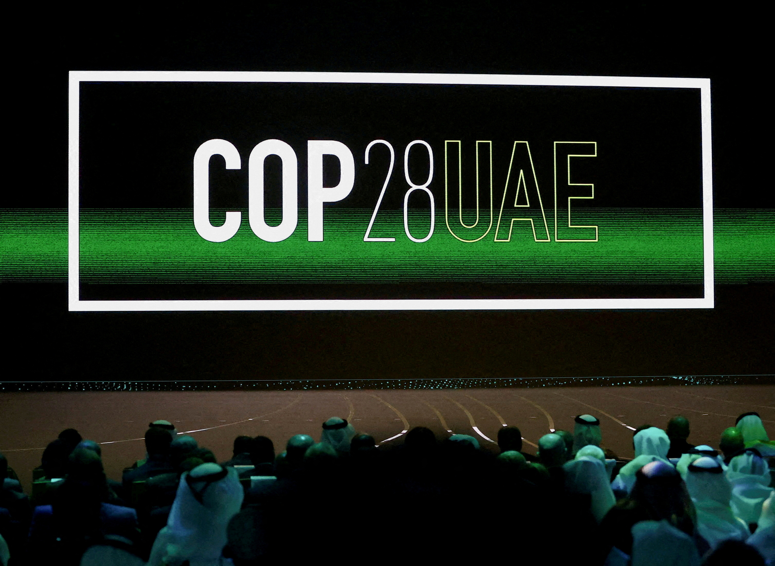 'Cop28 UAE' logo is displayed on the screen during the opening ceremony of Abu Dhabi Sustainability Week (ADSW) under the theme of 'United on Climate Action Toward COP28', in Abu Dhabi