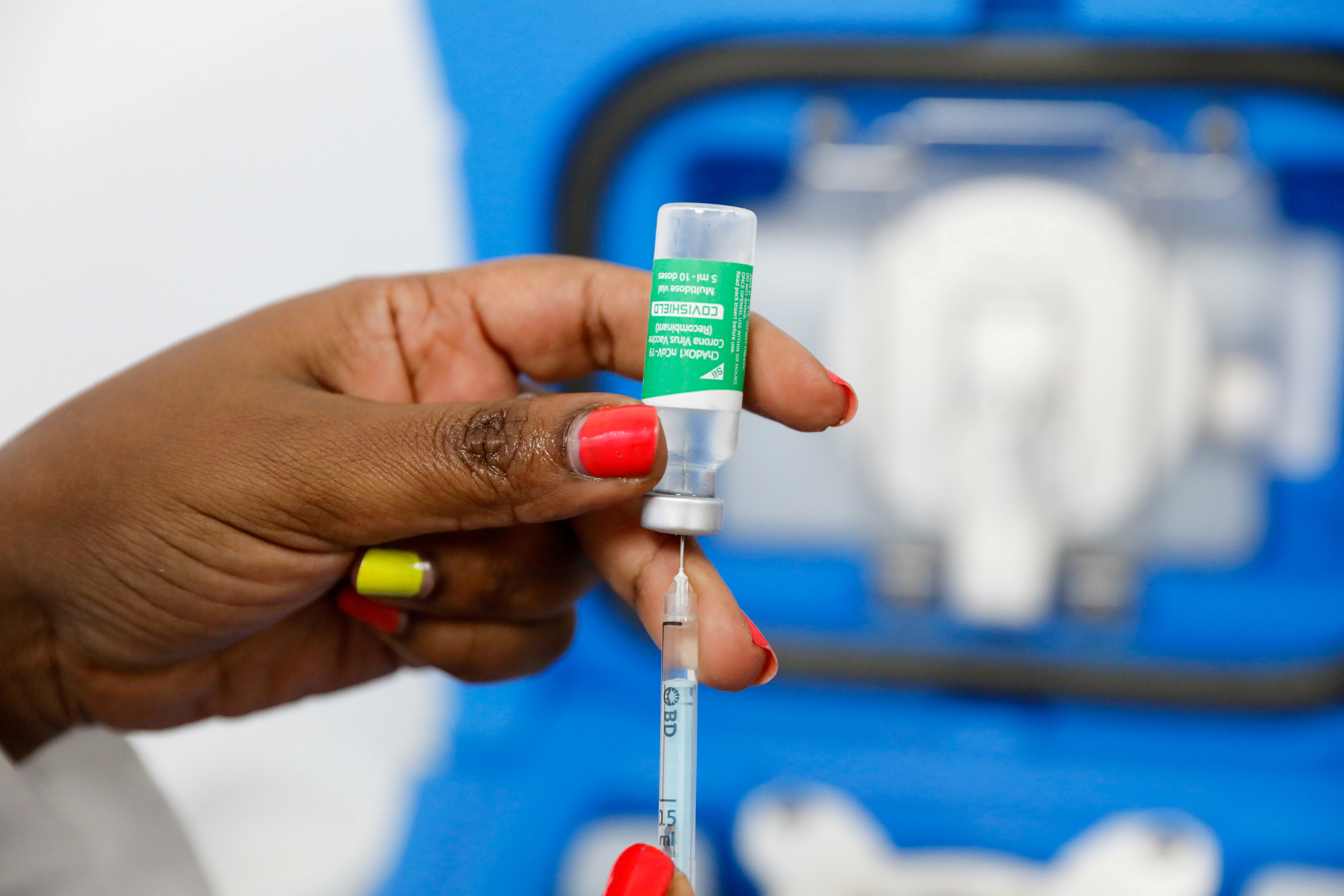 A medical worker prepares a dose of AstraZeneca's COVID-19 vaccine, in Nairobi