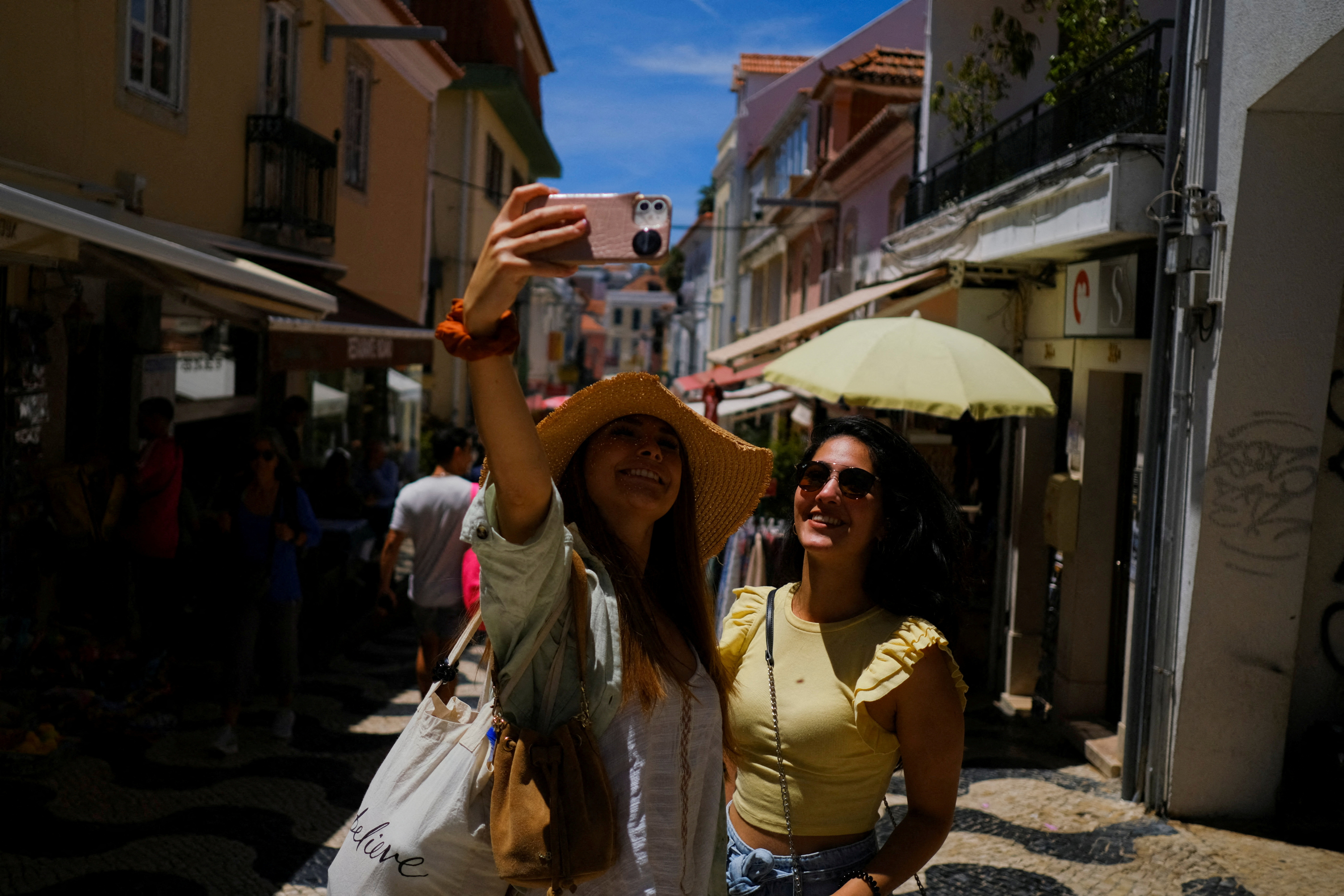 Tourists take a picture on a street in Cascais