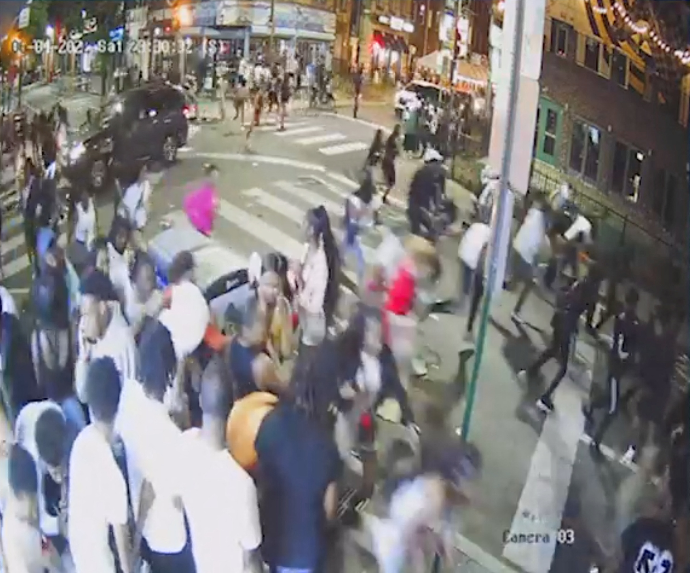 A screen grab from a surveillance video from the shooting shows people on a crowded street running in panic, presumably after gun shots were fired, in Philadelphia, Pennsylvania