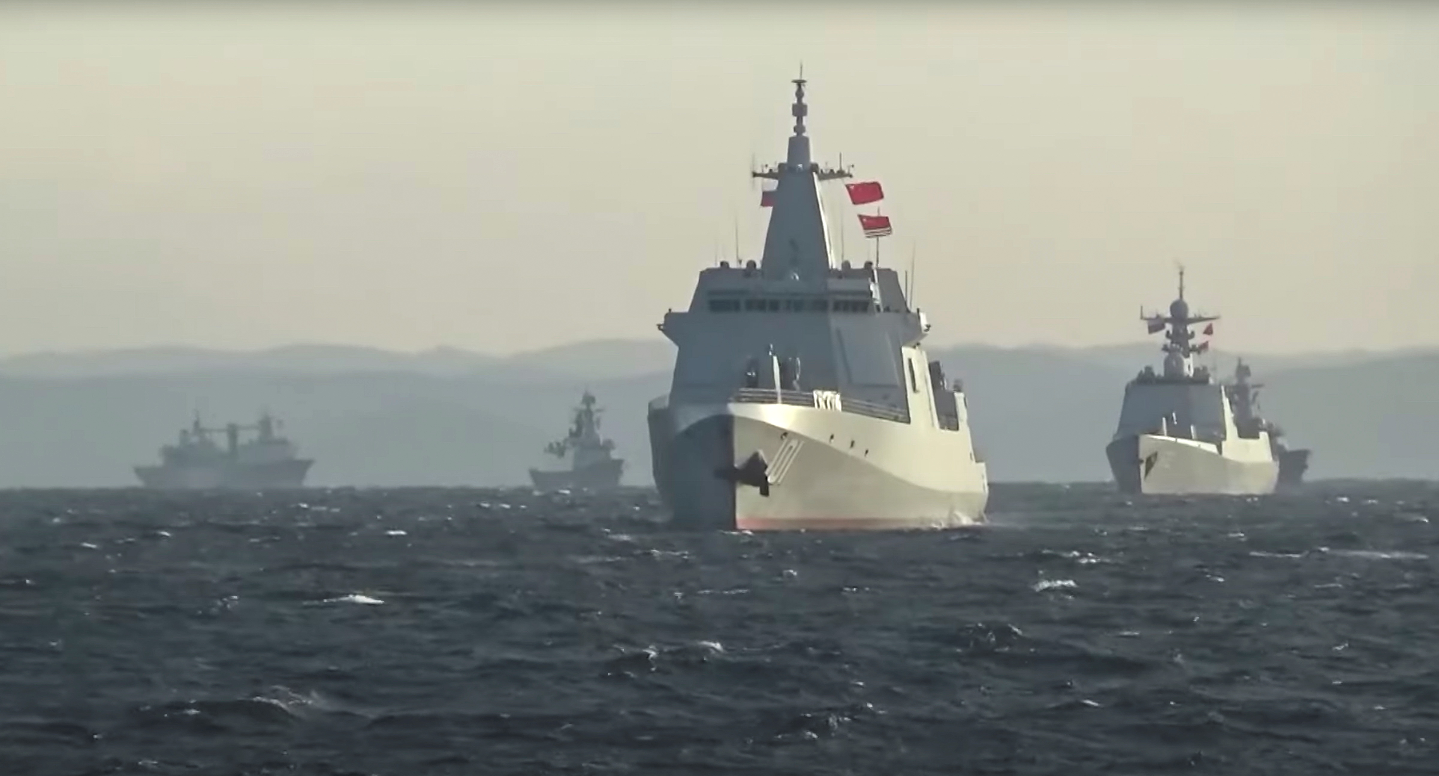 A group of naval vessels from China and Russia sail during joint military drills in the Sea of Japan