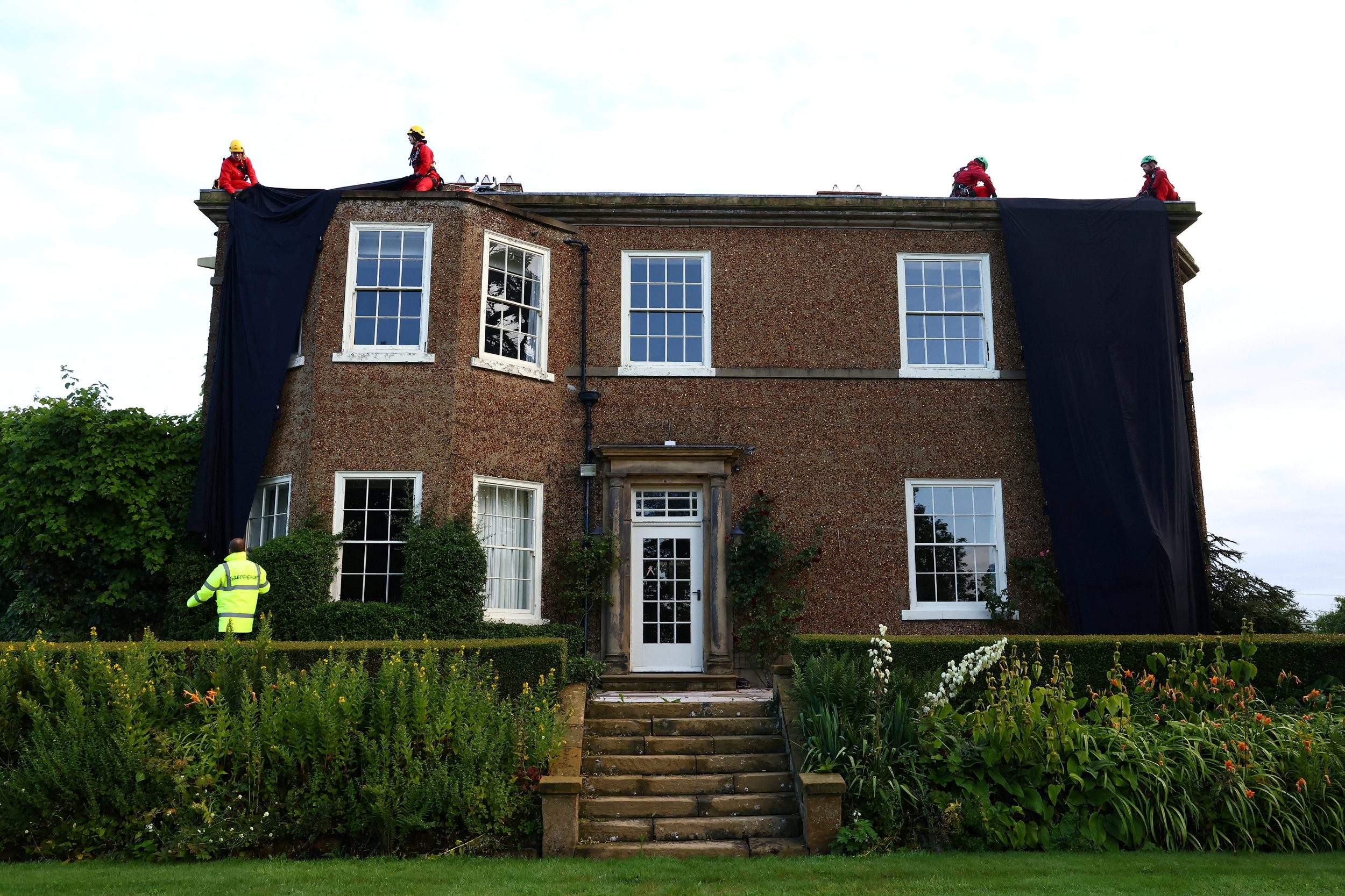 Greenpeace oil protesters cover Rishi Sunak's home in black fabric ...