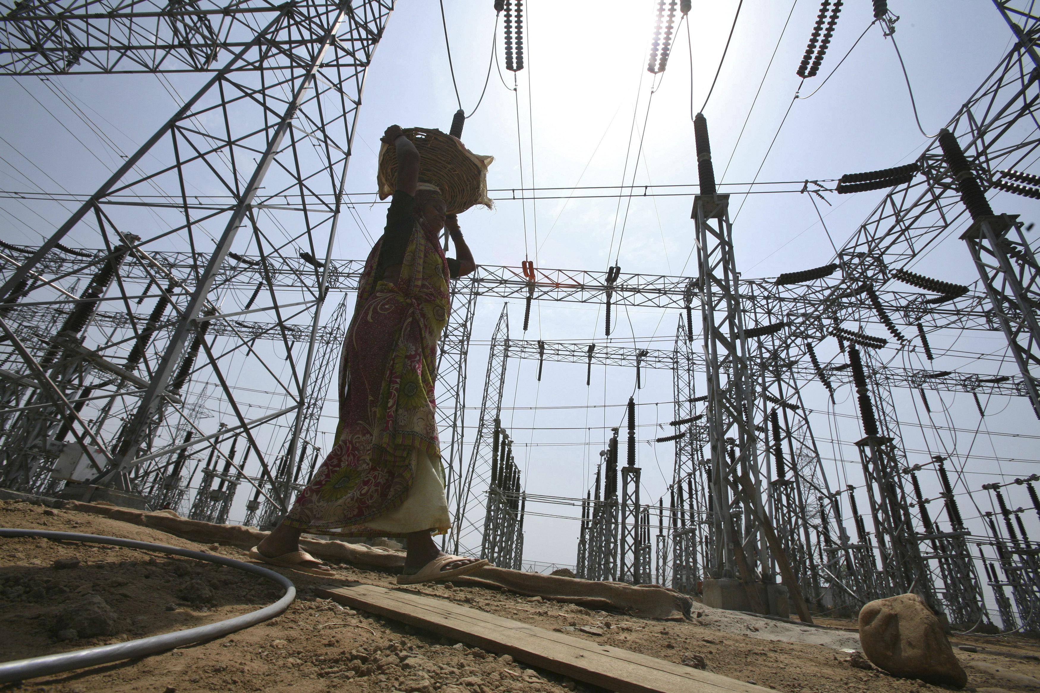 A labourer works at the construction site of a grid power station in Jammu