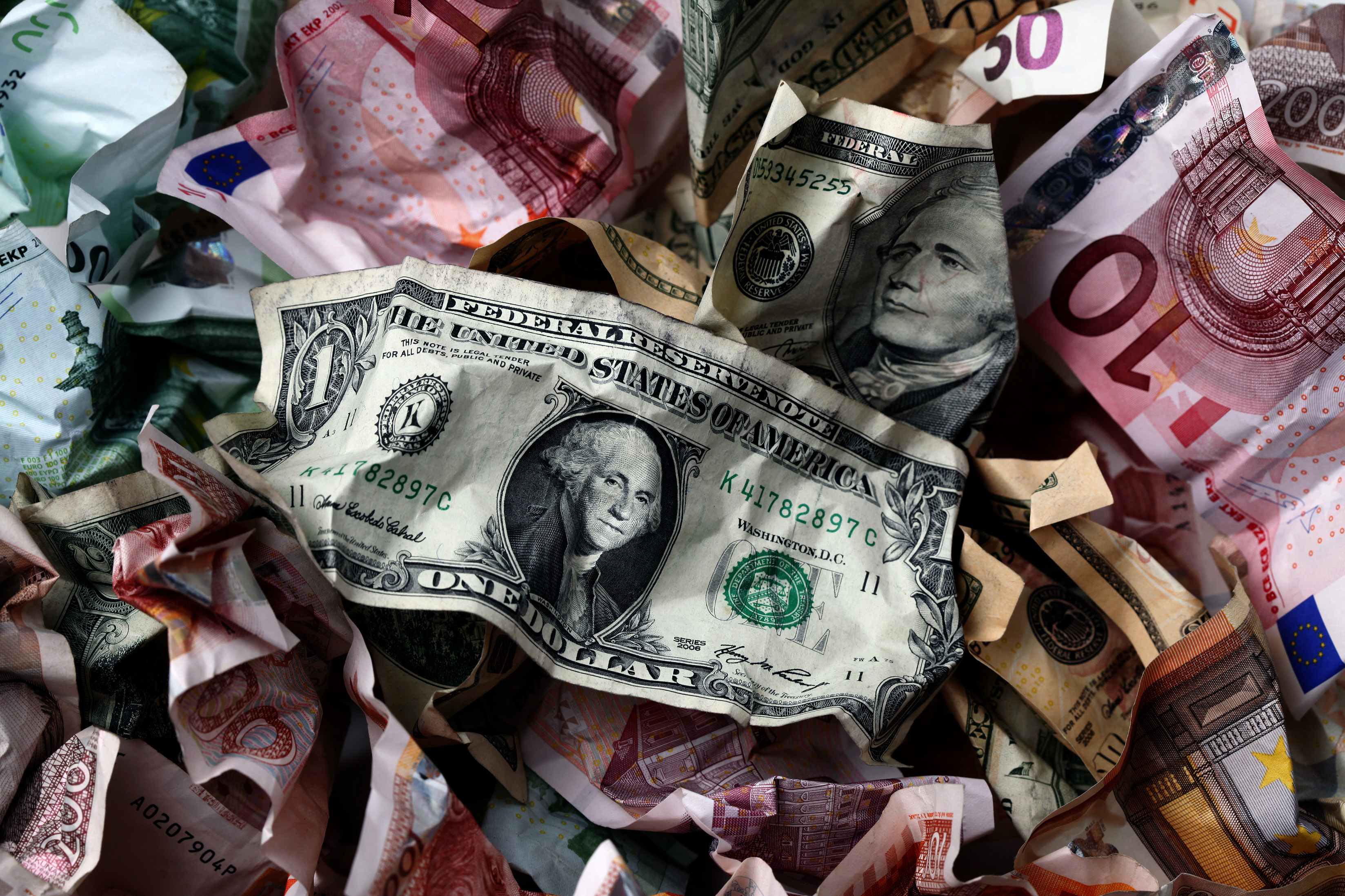 A picture illustration of crumpled kuna, Dollar and euro banknotes