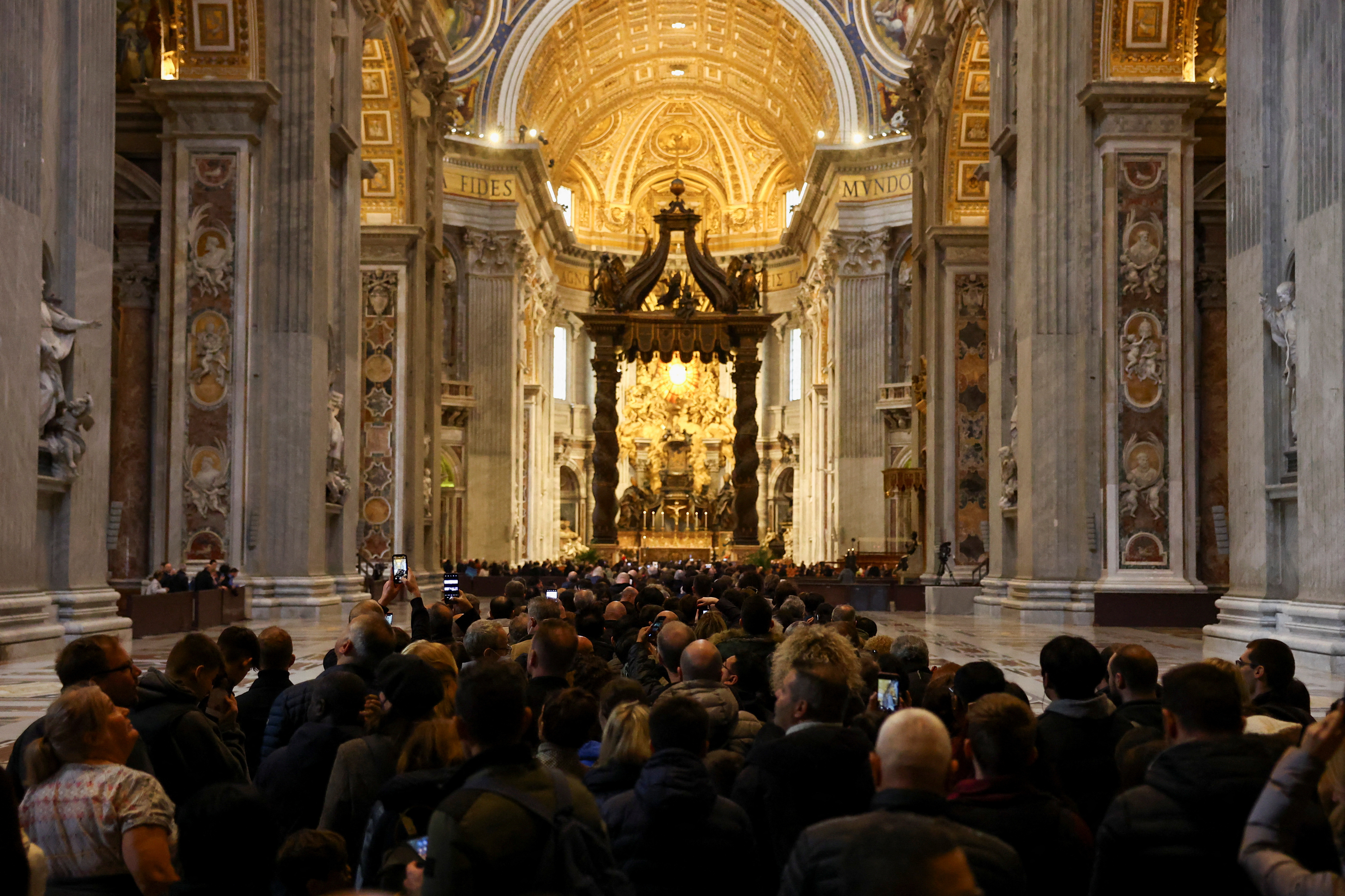 The faithful pay tribute to former Pope Benedict at St. Peter's Basilica in the Vatican.