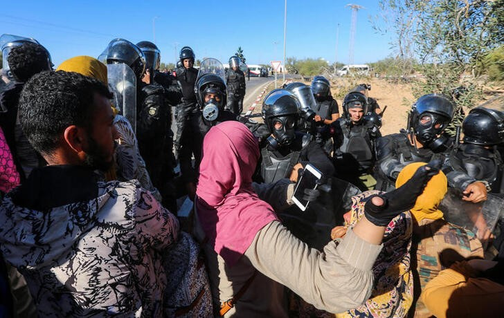 Members of the police confront with protesters in the town of Zarzis