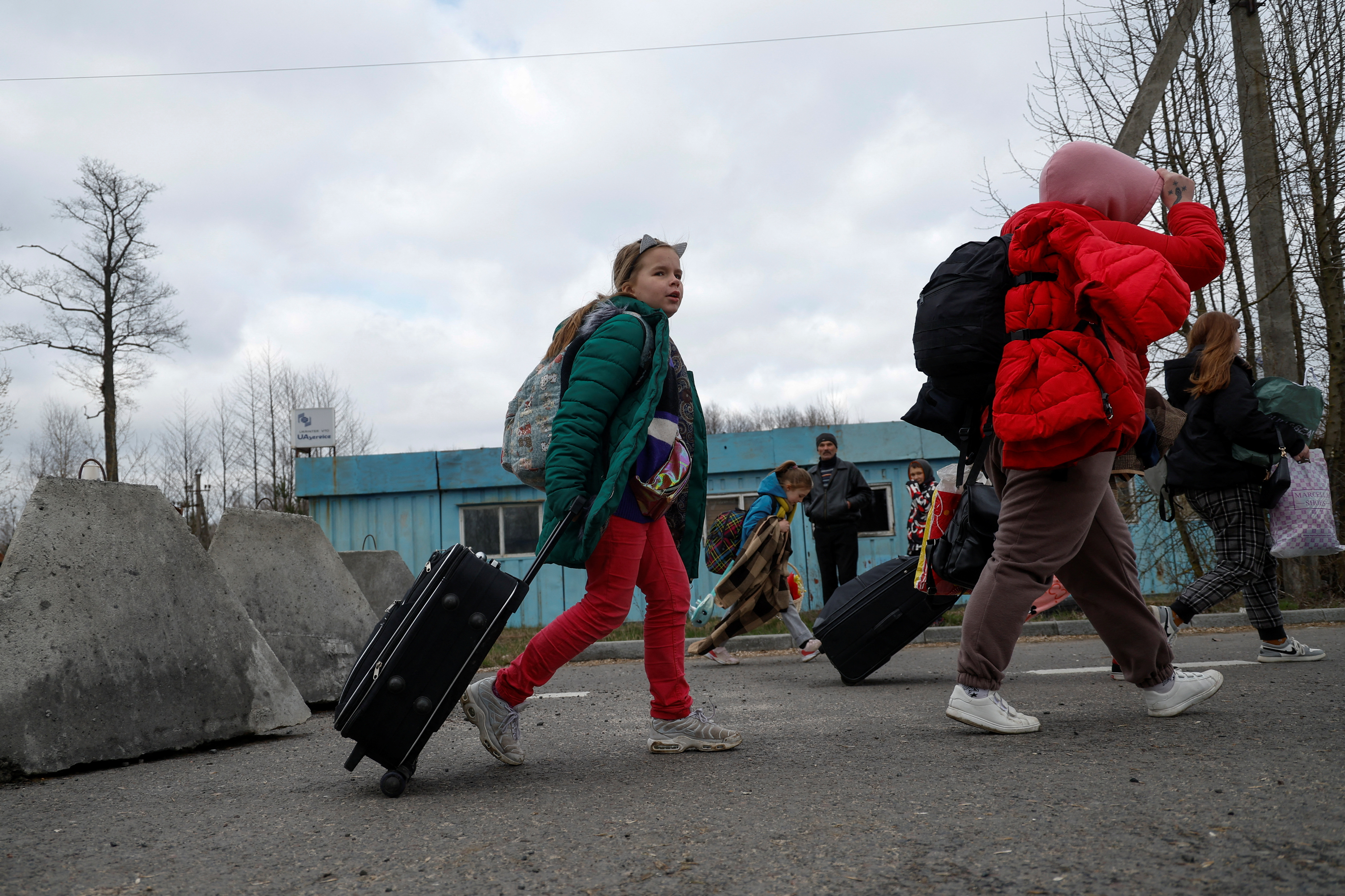 10-year-old Kira walks after crossing the Belarus-Ukraine border, in Volyn region