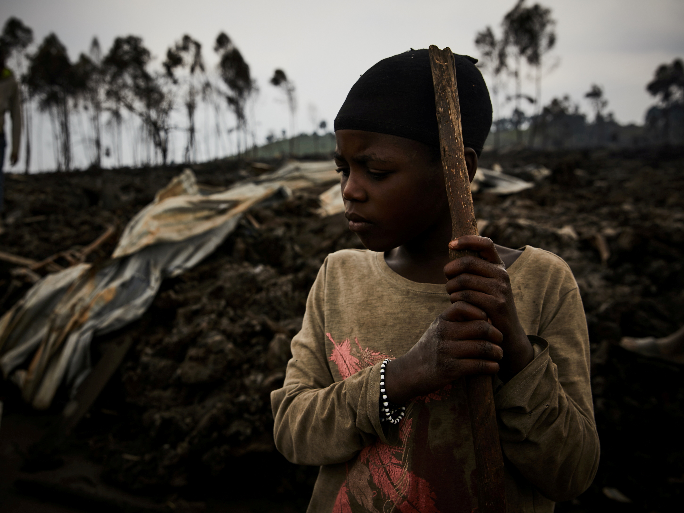 A Congolese child, Jolie, 11, prepares to evacuate from recurrent earth tremors as aftershocks after homes were covered with lava deposited by the eruption of Mount Nyiragongo near Goma