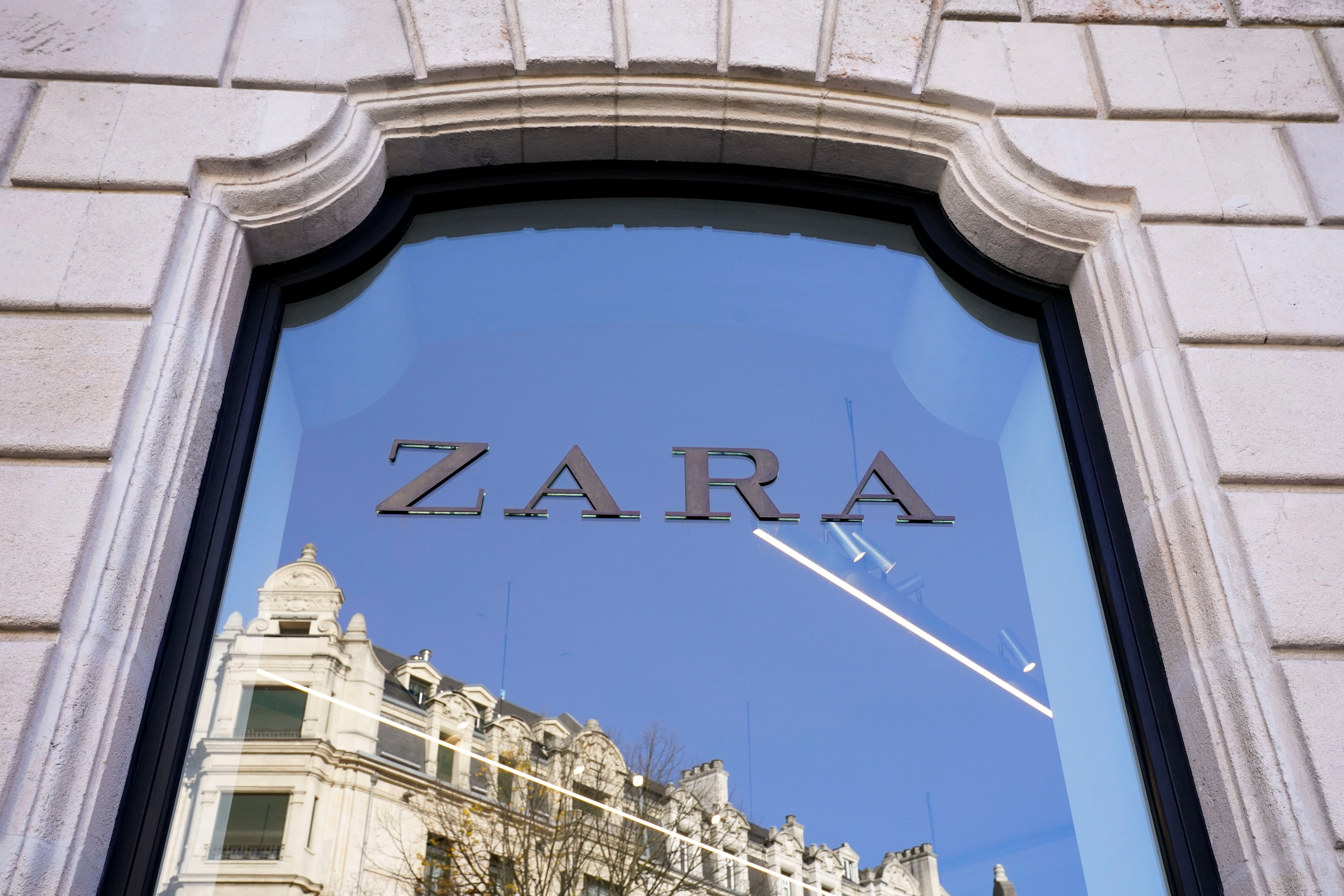 A building is reflected in the window of a Zara clothes store in Bilbao