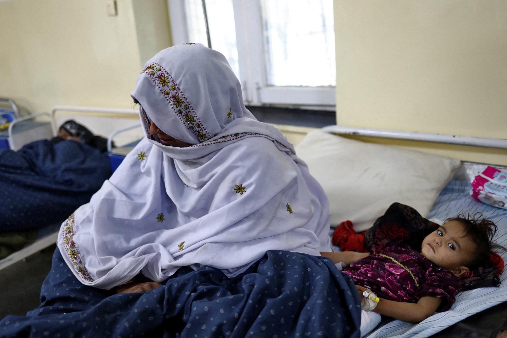 Bibi Hawa and her daughter Safia from the quake-hit area of Barmal, receive treatment at a hospital ward in Sharana