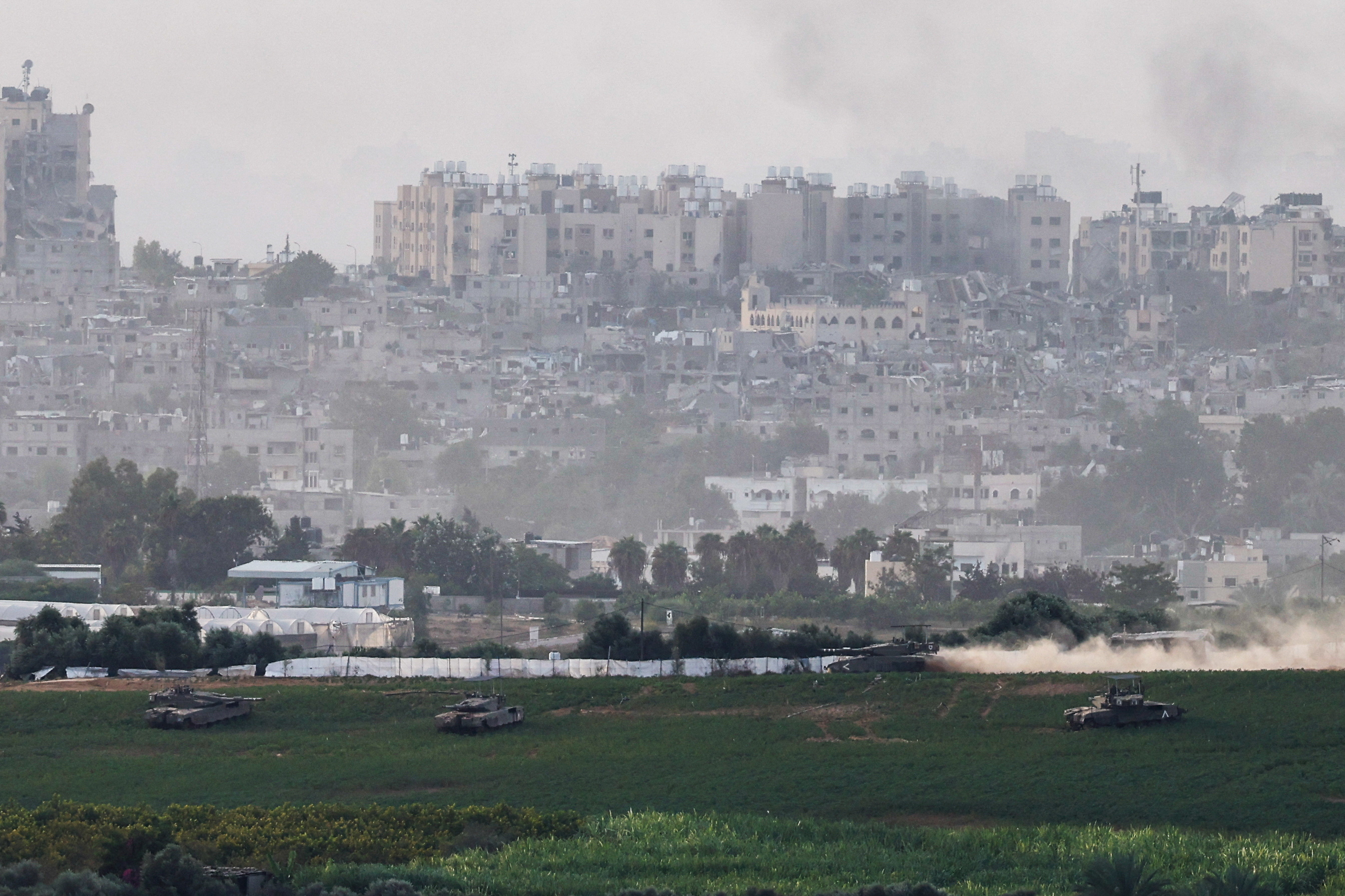 Israeli tanks manoeuvre inside the Gaza Strip, as seen from Israel
