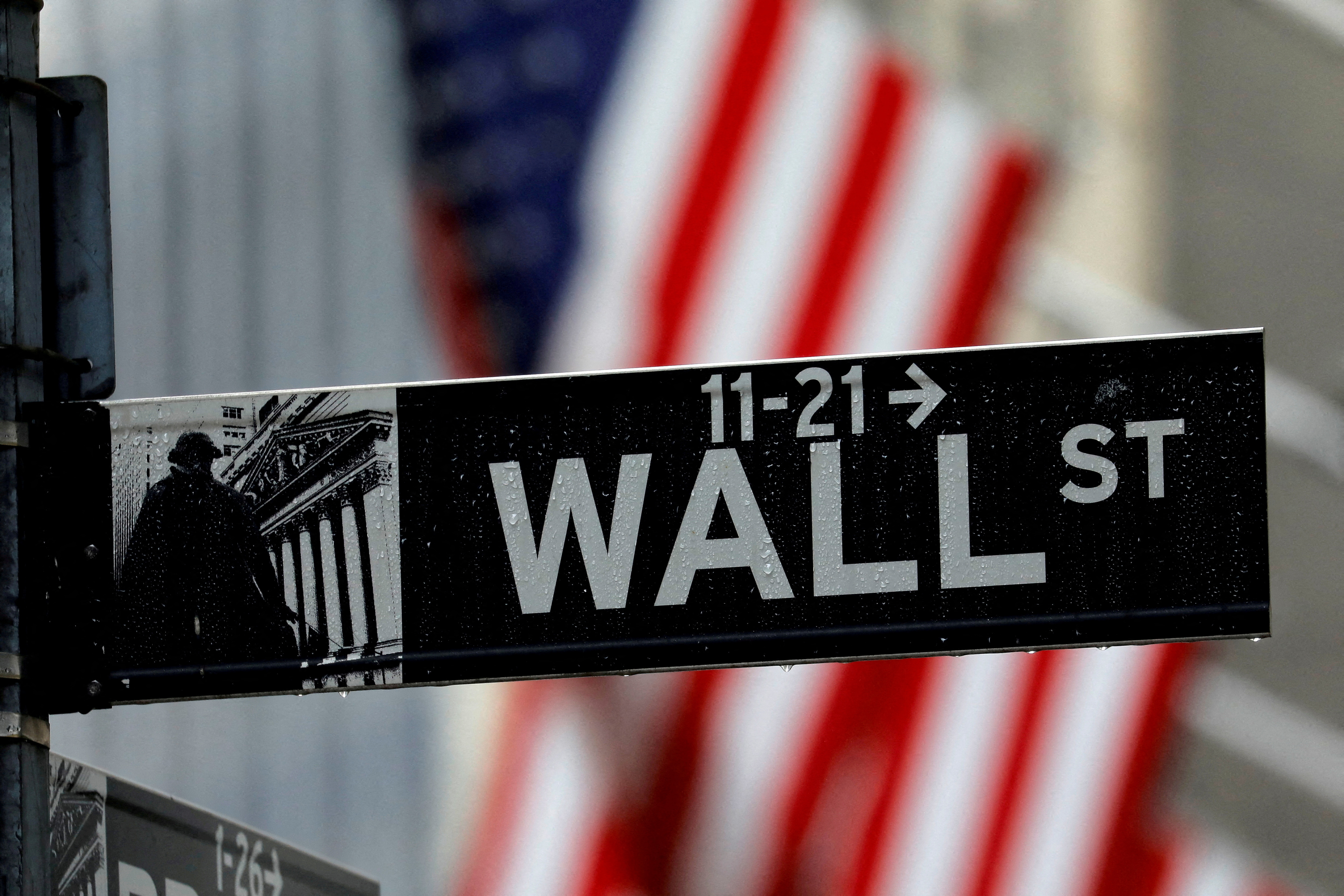 Raindrops hang on a sign for Wall Street outside the New York Stock Exchange in New York