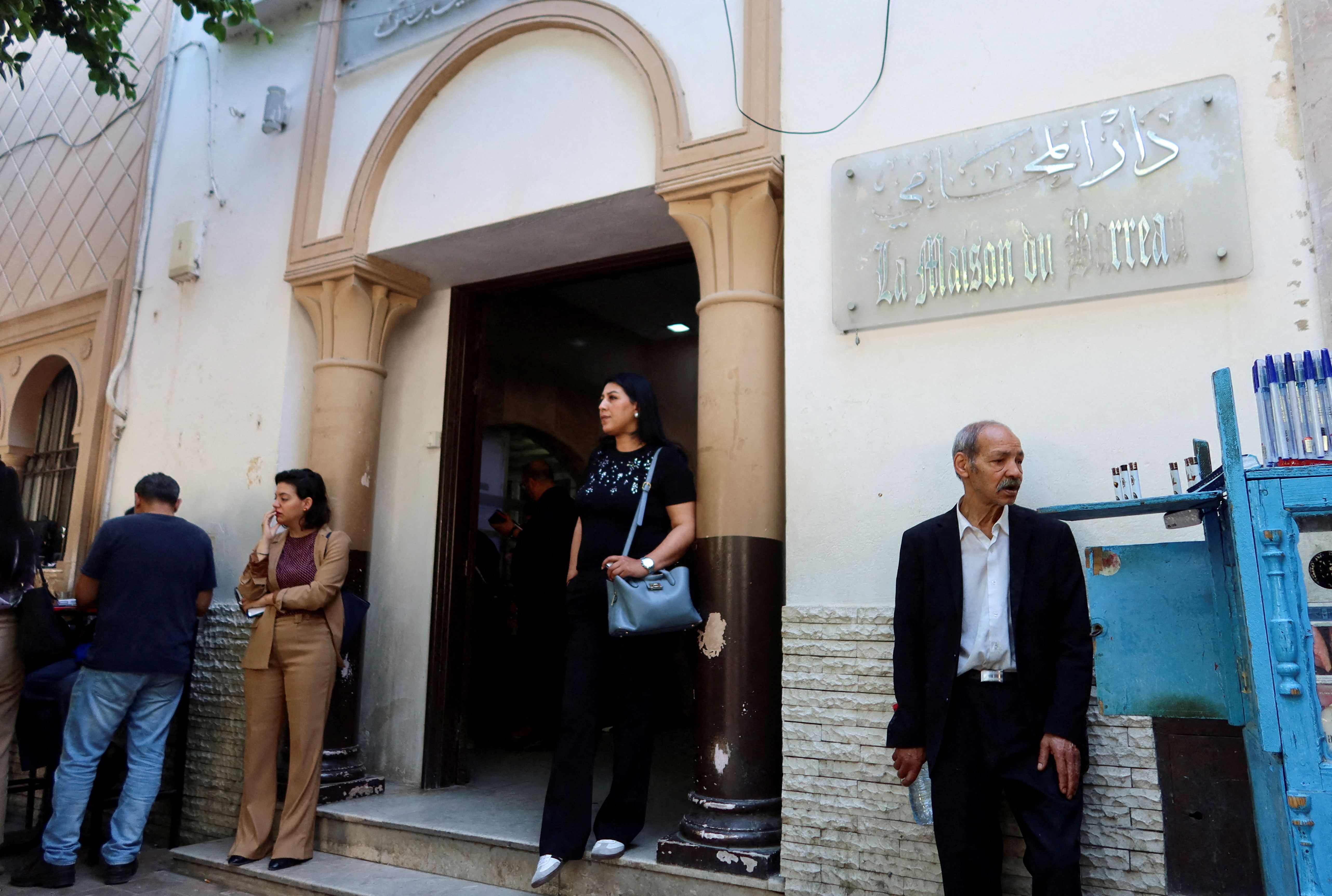 A woman walks out of the building of the Deanship of Lawyers in Tunis