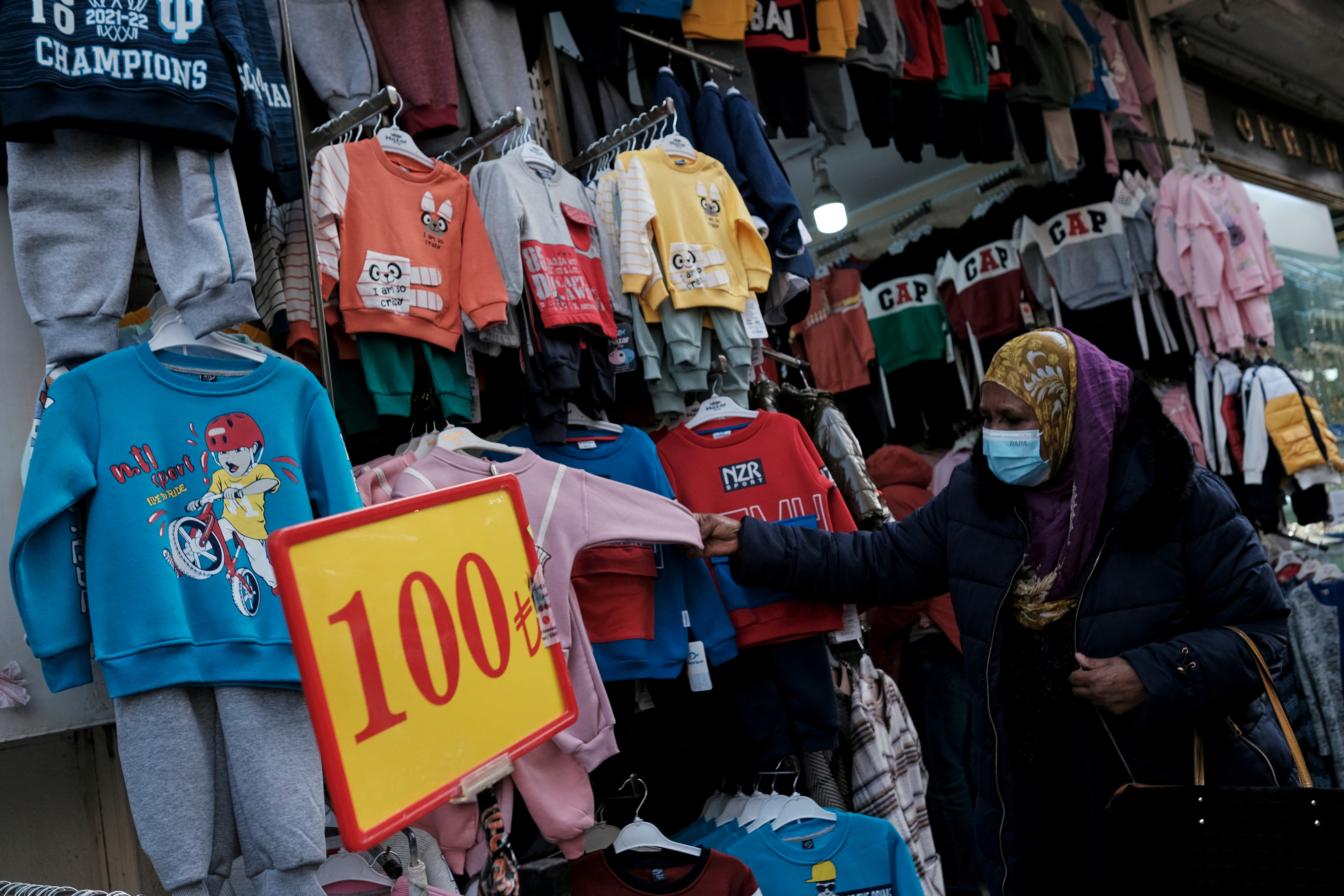 A tourist shops for clothes at Mahmutpasa street, a popular middle-class shopping district, in Istanbul