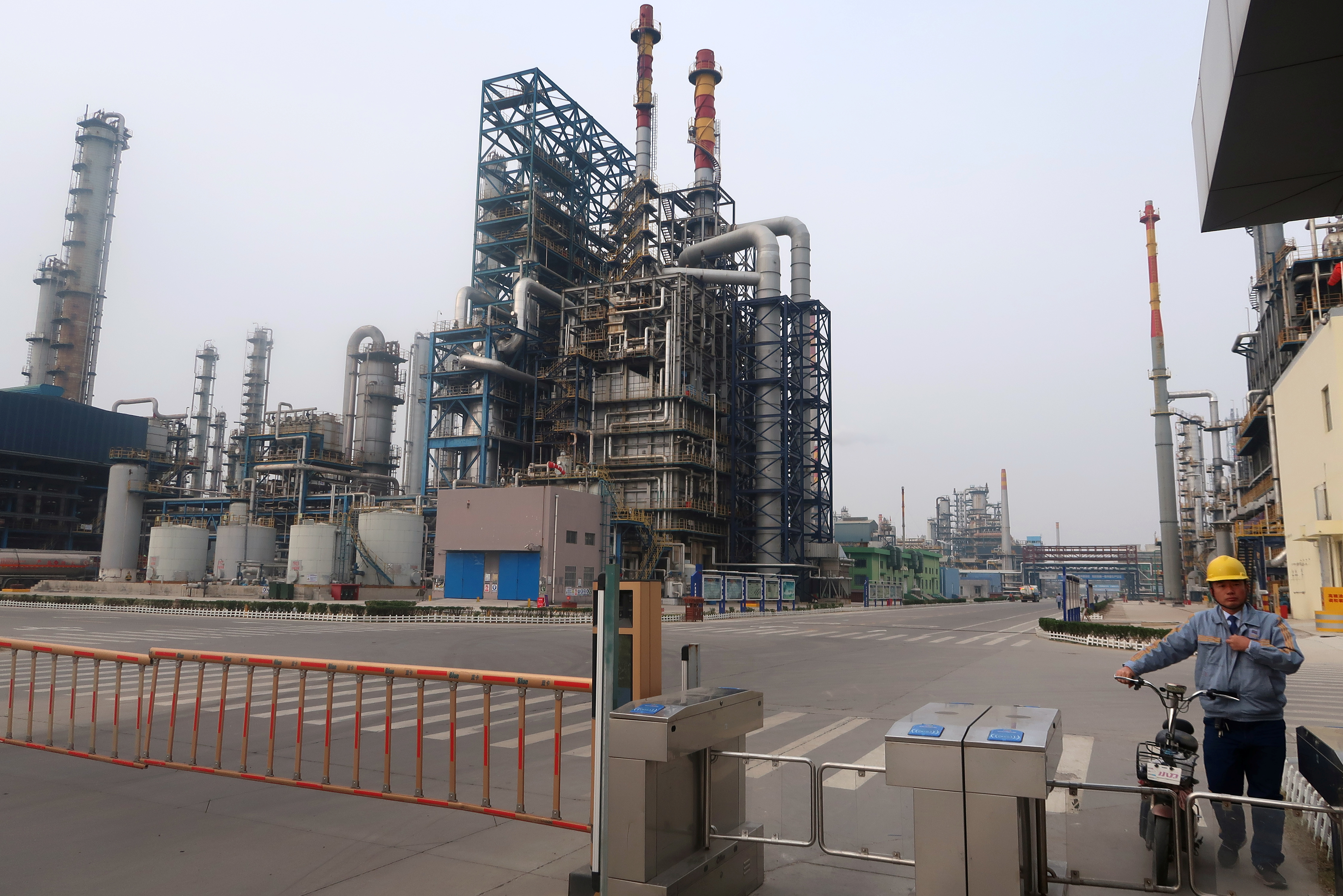 Man is seen at an exit of the refinery plants of Chambroad Petrochemicals in Binzhou, Shandong