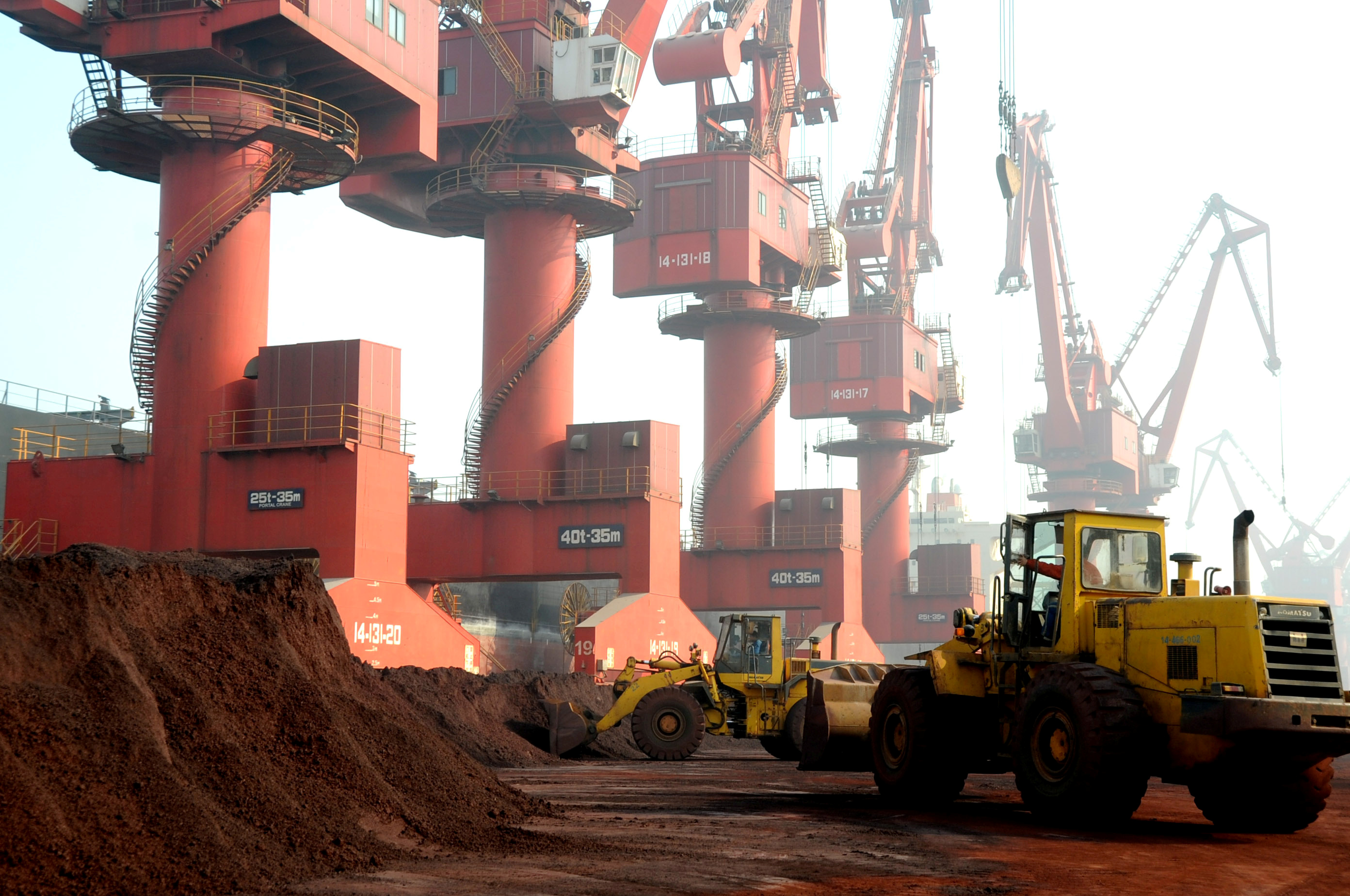 Workers transport soil containing rare earth elements for export at a port in Lianyungang, Jiangsu province, China October 31, 2010. REUTERS/Stringer/File Photo 