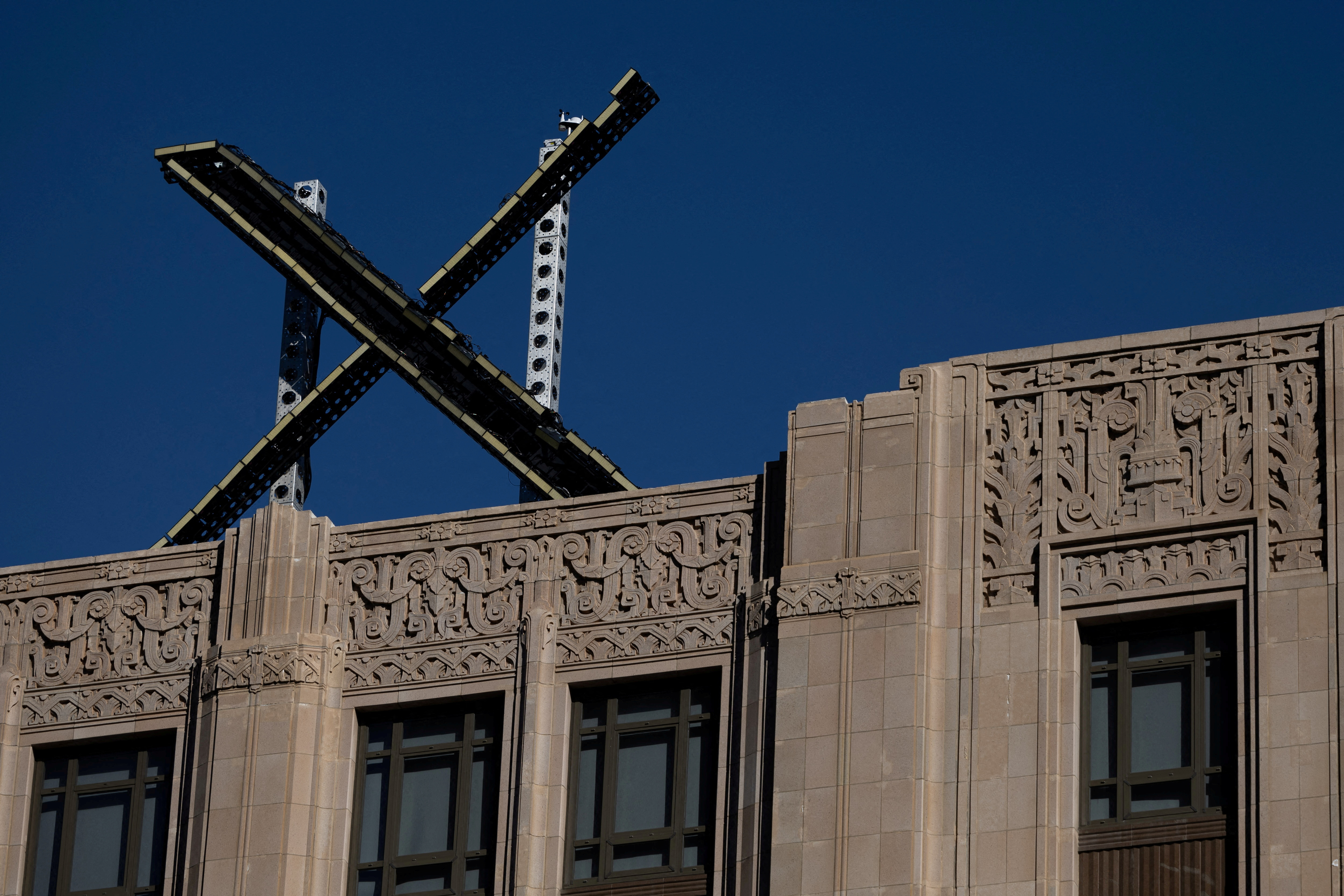 'X' logo is seen on the top of the headquarters of the messaging platform X, formerly known as Twitter in San Francisco