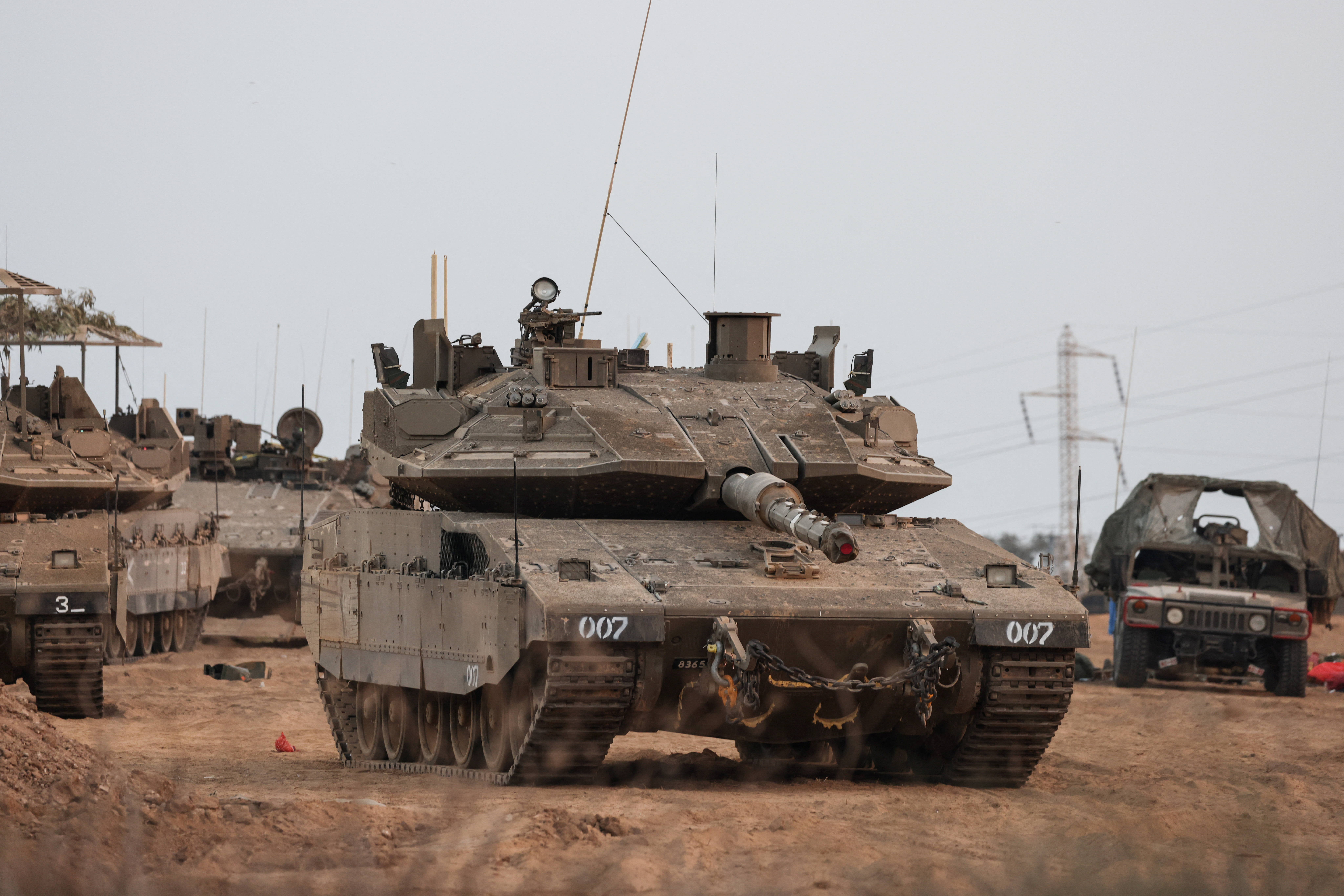 An Israeli tank and military vehicles are seen near Israel's border with the Gaza Strip, in southern Israel