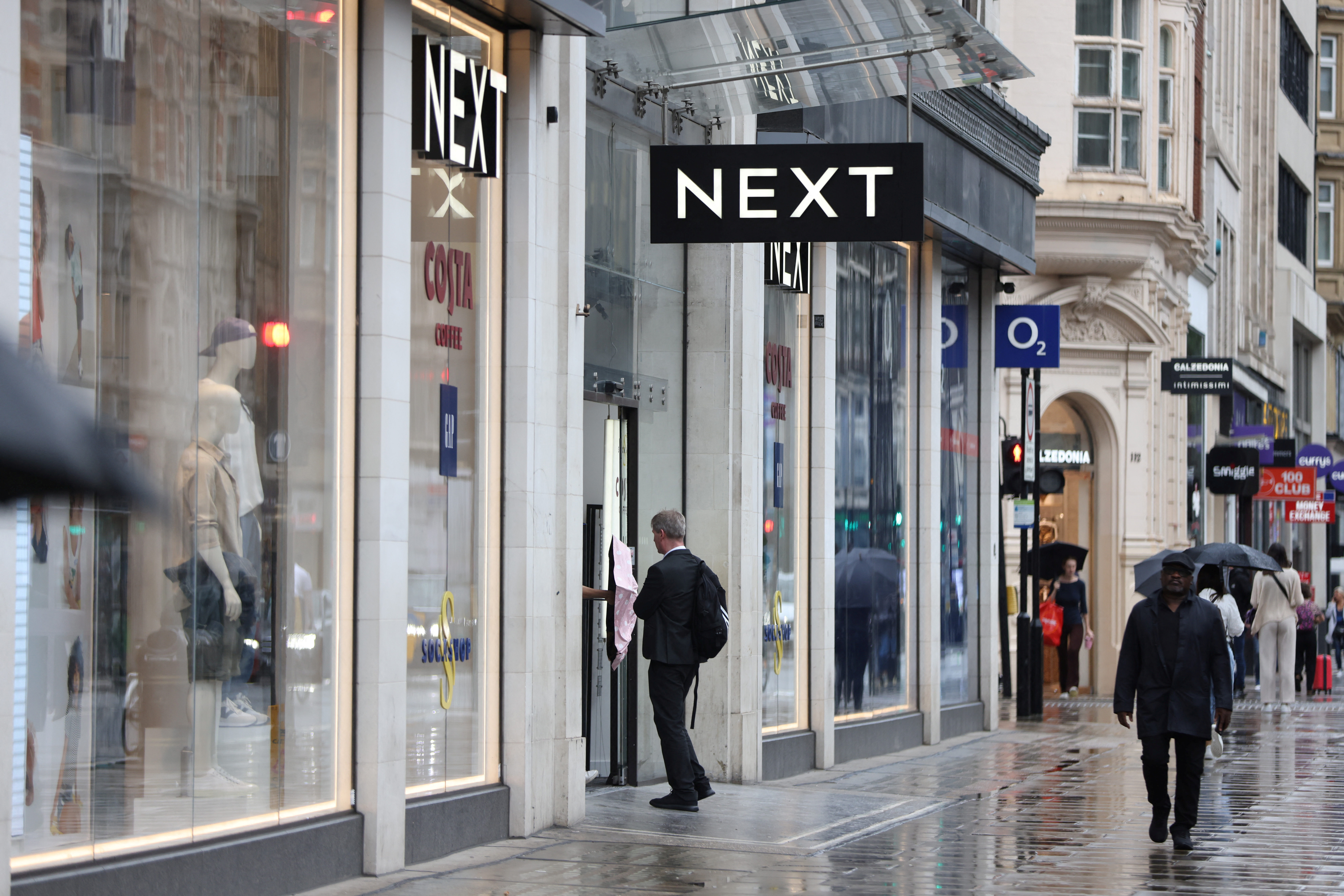 us'A shopper enters a Next store on Oxford Street in London
