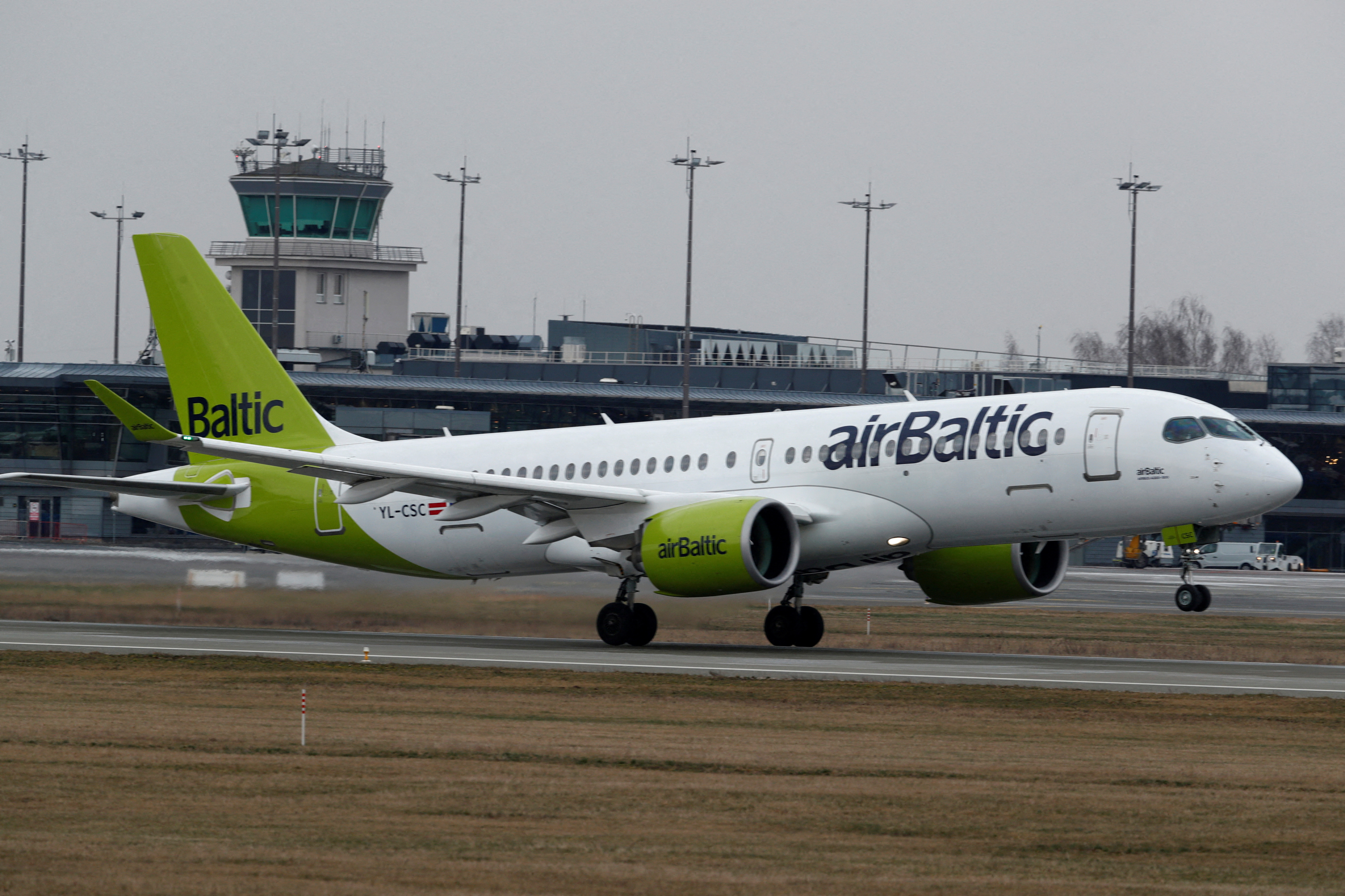 AirBaltic Airbus A220-300 plane takes off before all international flights will be cancelled on Monday midnight, March 16, Riga