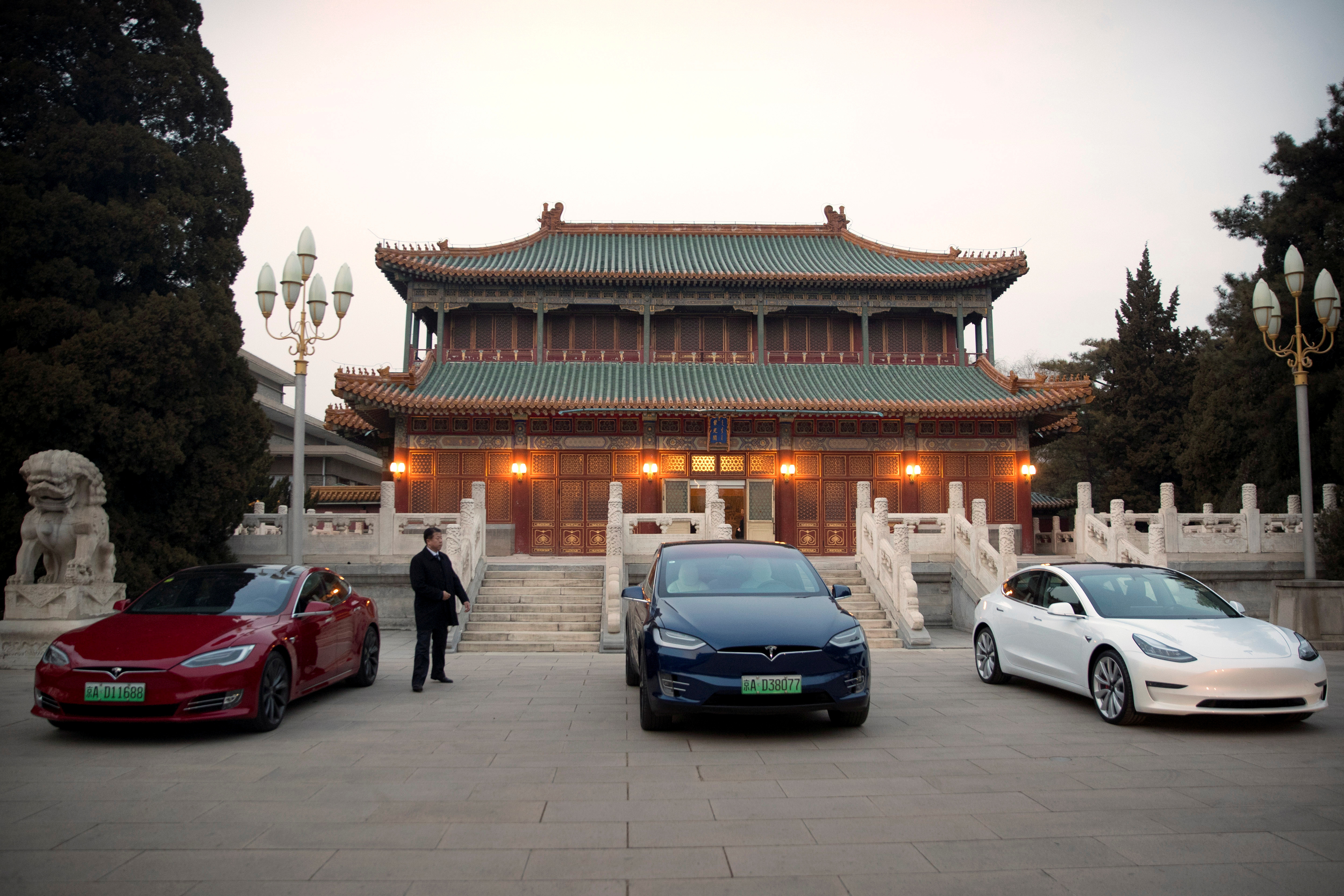 Tesla vehicles are parked outside of a building at the Zhongnanhai leadership compound during a meeting between Tesla CEO Elon Musk and Chinese Premier Li Keqiang in Beijing