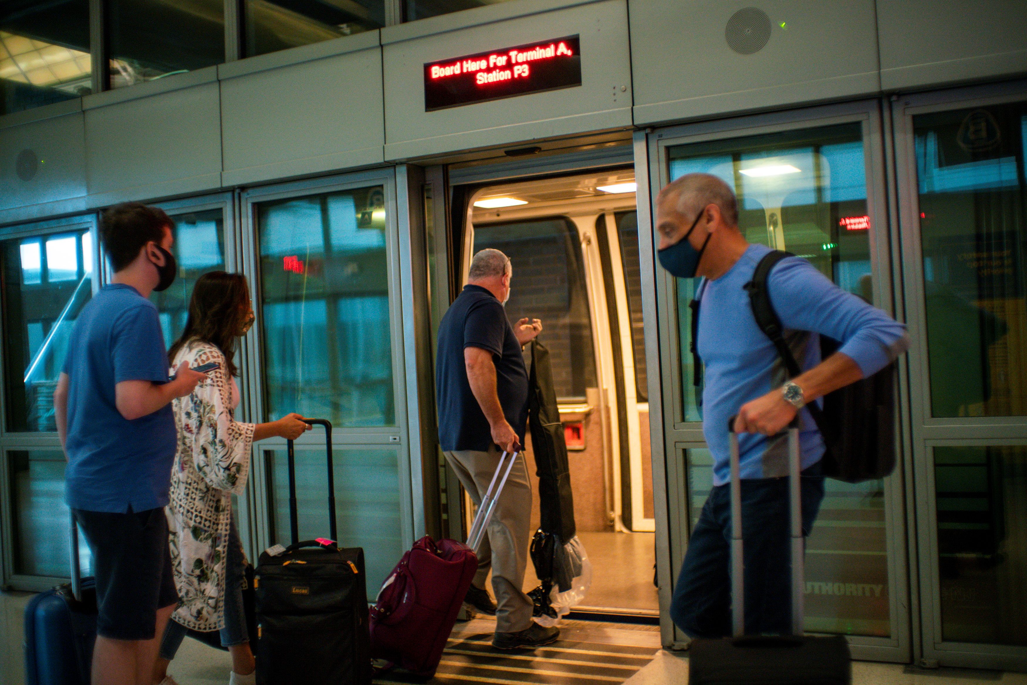 Travelers board the air train ahead of the July 4th holiday, at the Newark Liberty International Airport, in Newark, New Jersey