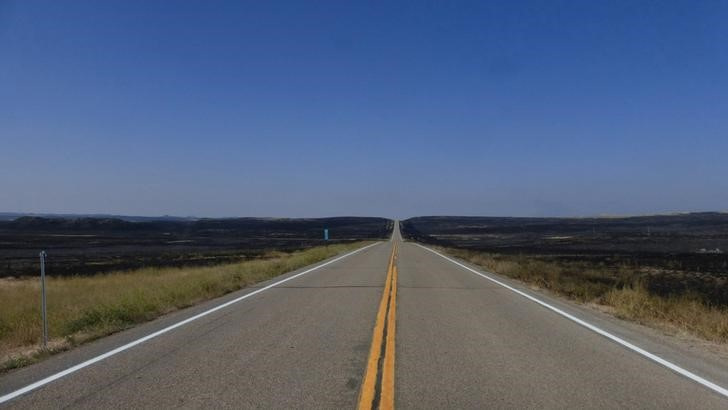 Blackened range remains on both sides of the Montana 200 highway between Sand Springs and Mosby where the Lodgepole Complex jumped the road