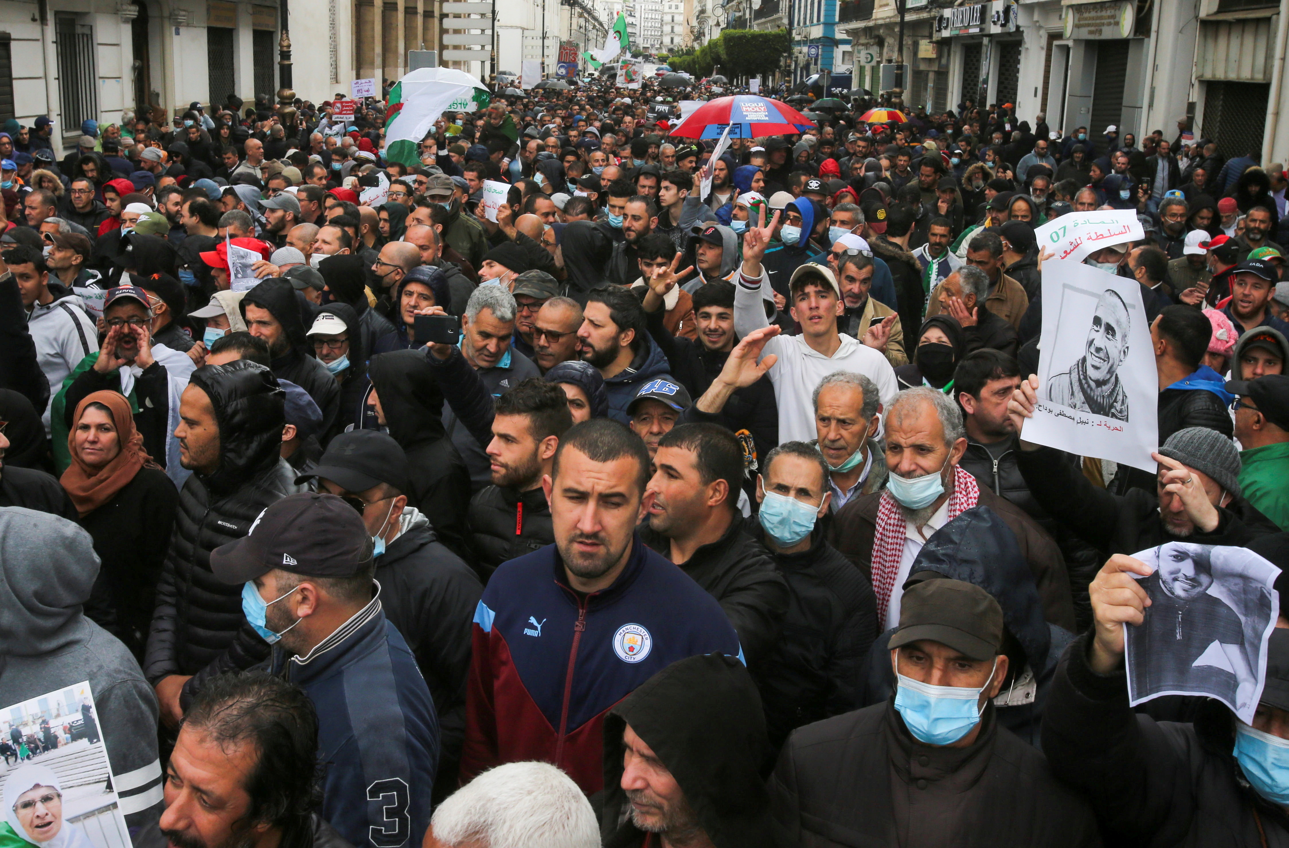 Demonstrators march during a protest demanding political change, in Algiers