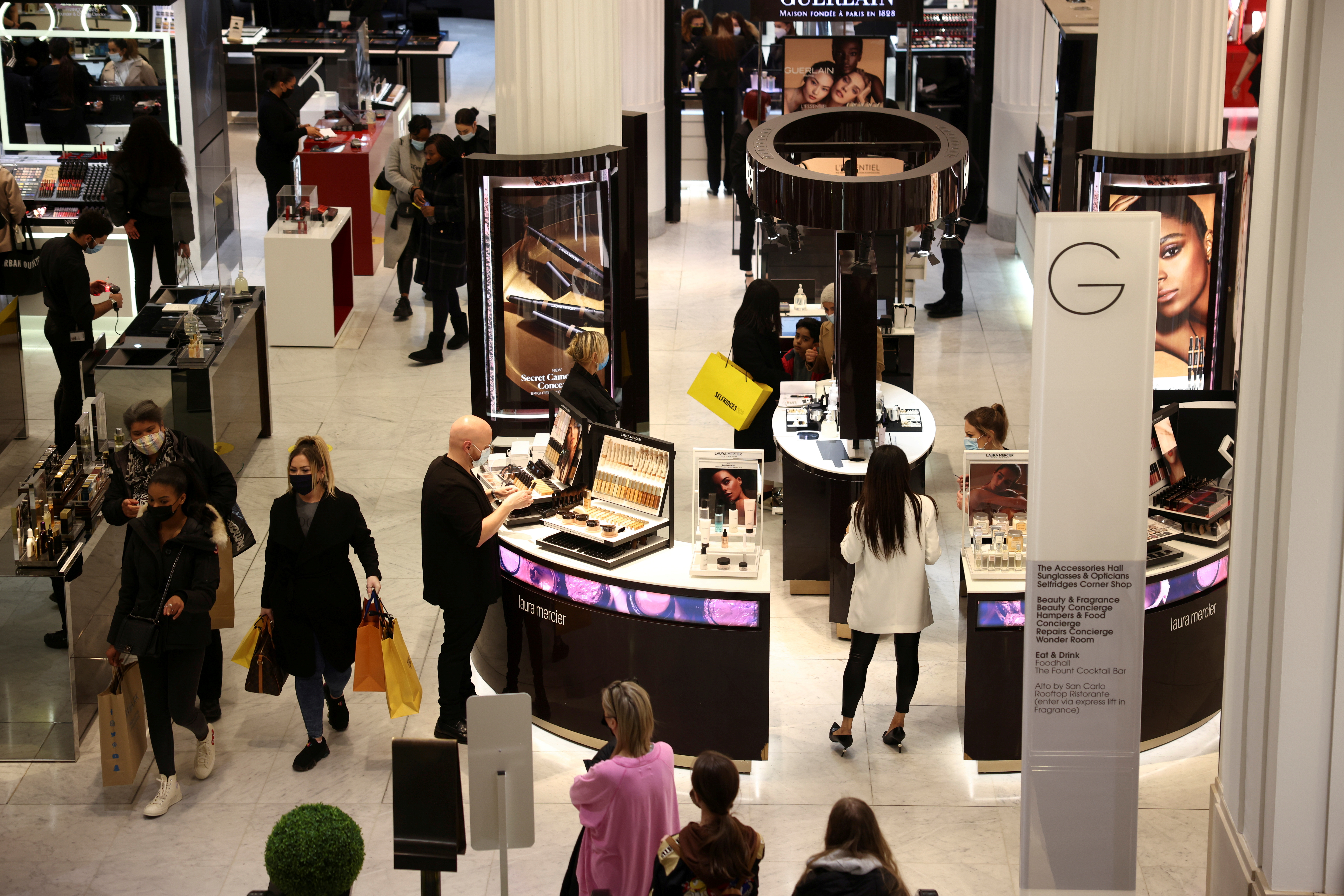 People shop in the Selfridges department store on Oxford street in London